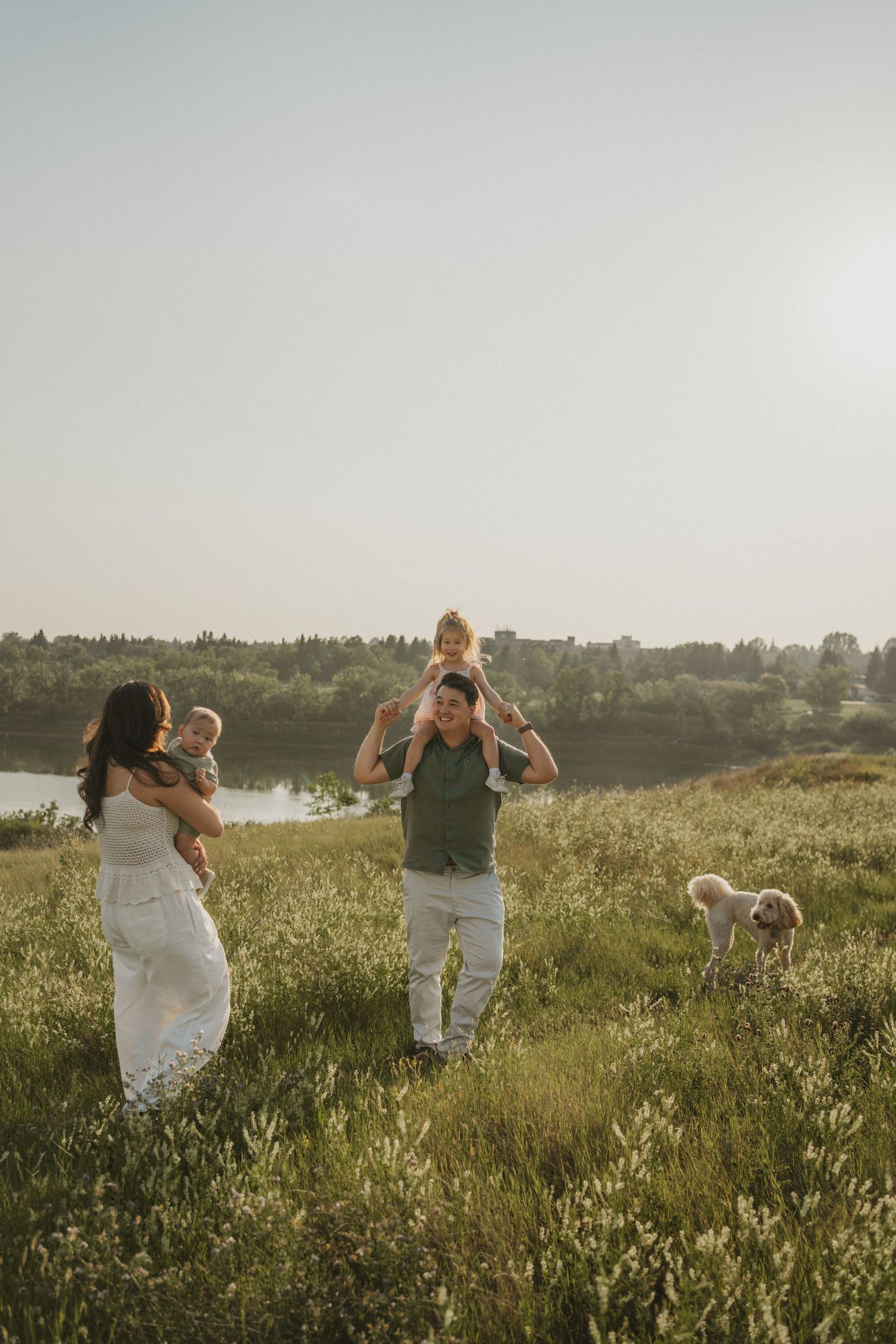 A photo of a family walking by the river. Candid and fun.