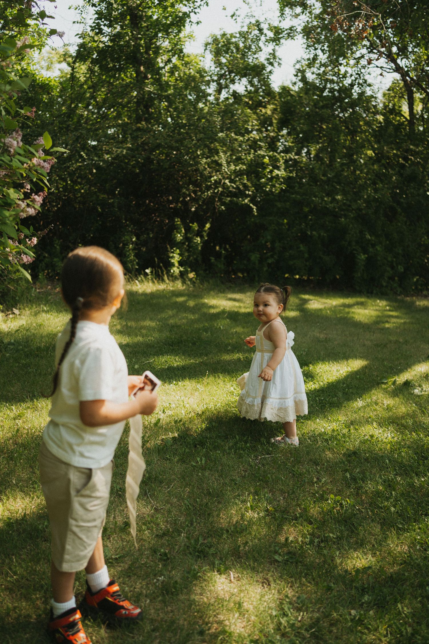 A photo of two children with an ultrasound of their new baby sibling.