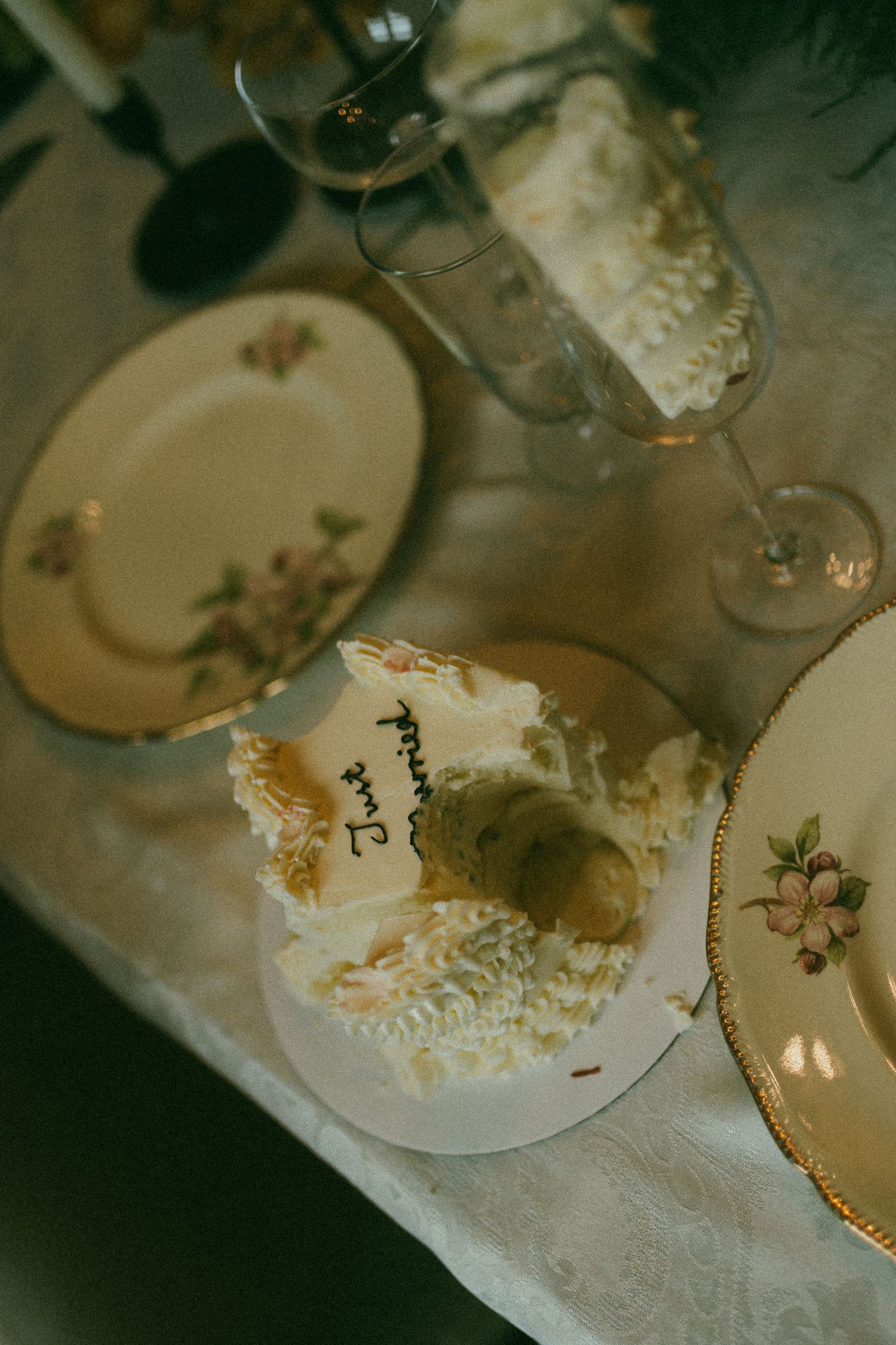 A photo of wedding details. Includes wedding cake, vintage dishes