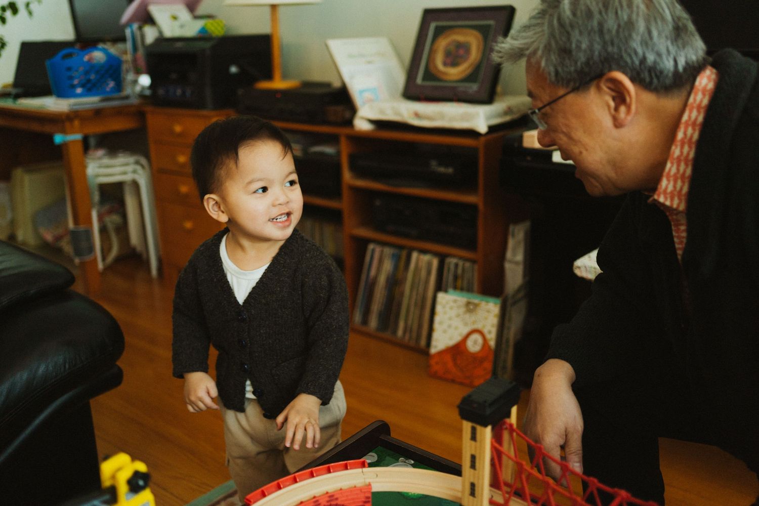 a man plays with his grandson