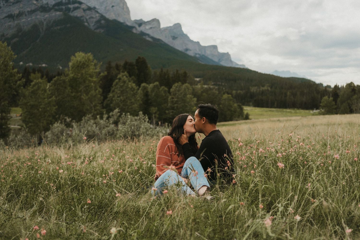 A couple shares a kiss in the Canadian Rockies, Canmore.