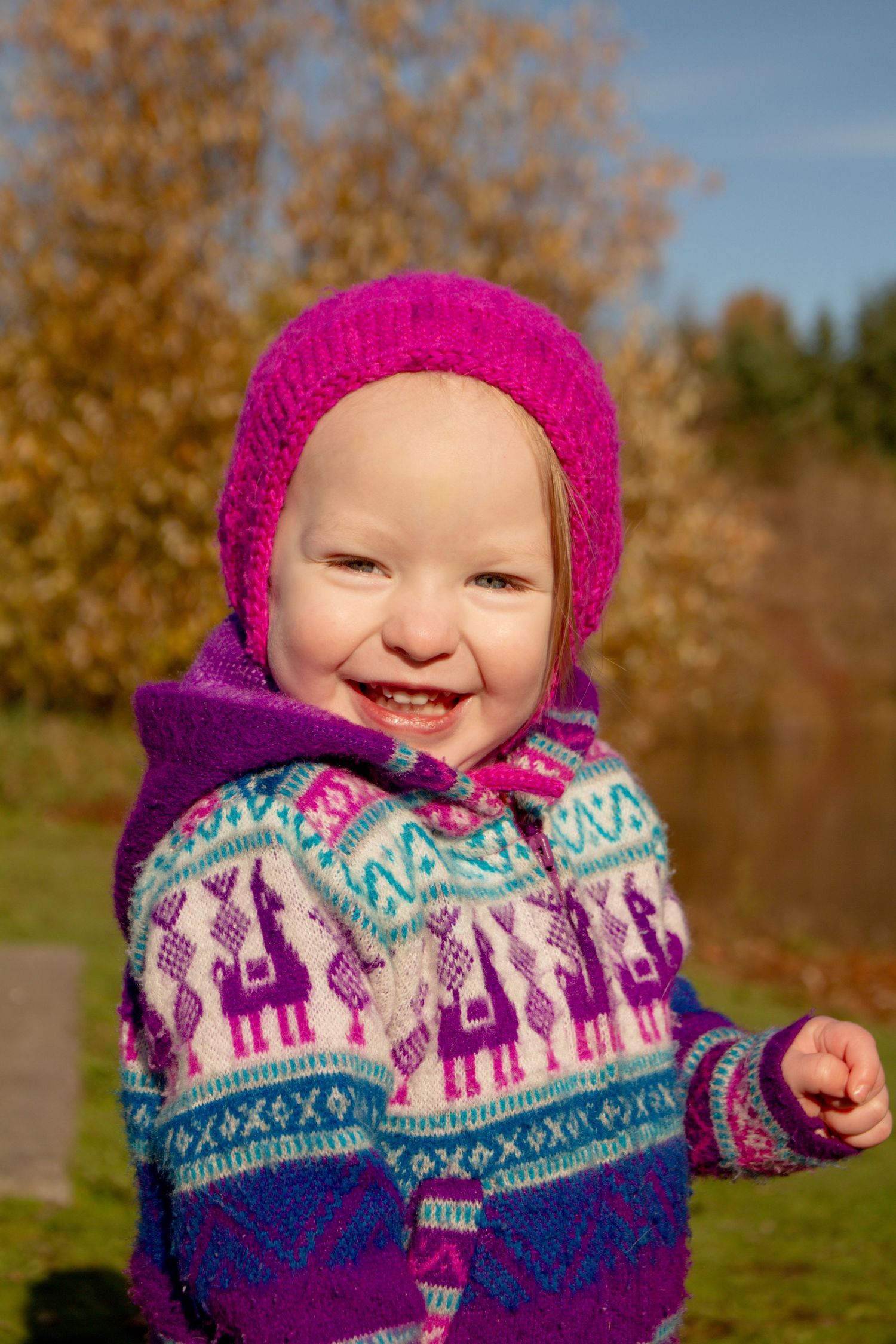 Colorful winter portrait showcasing a knit sweater with festive castle pattern.