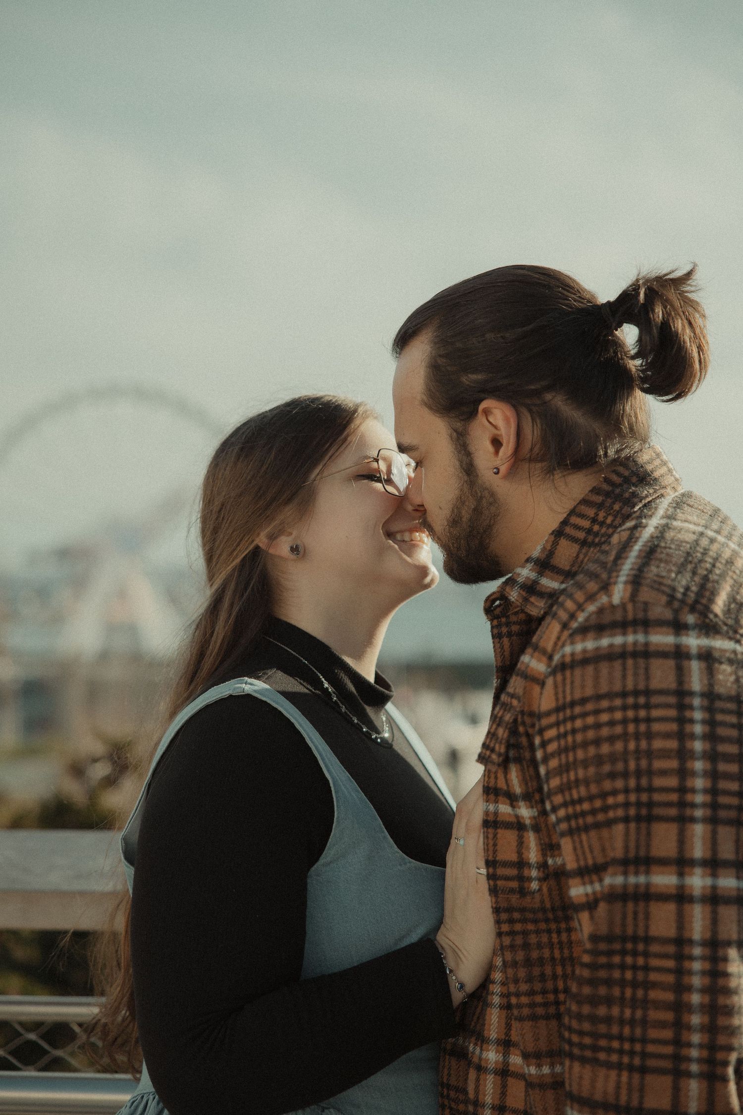 A couple shares intimate moments in a series of romantic outdoor photos against a soft, misty backdrop.
