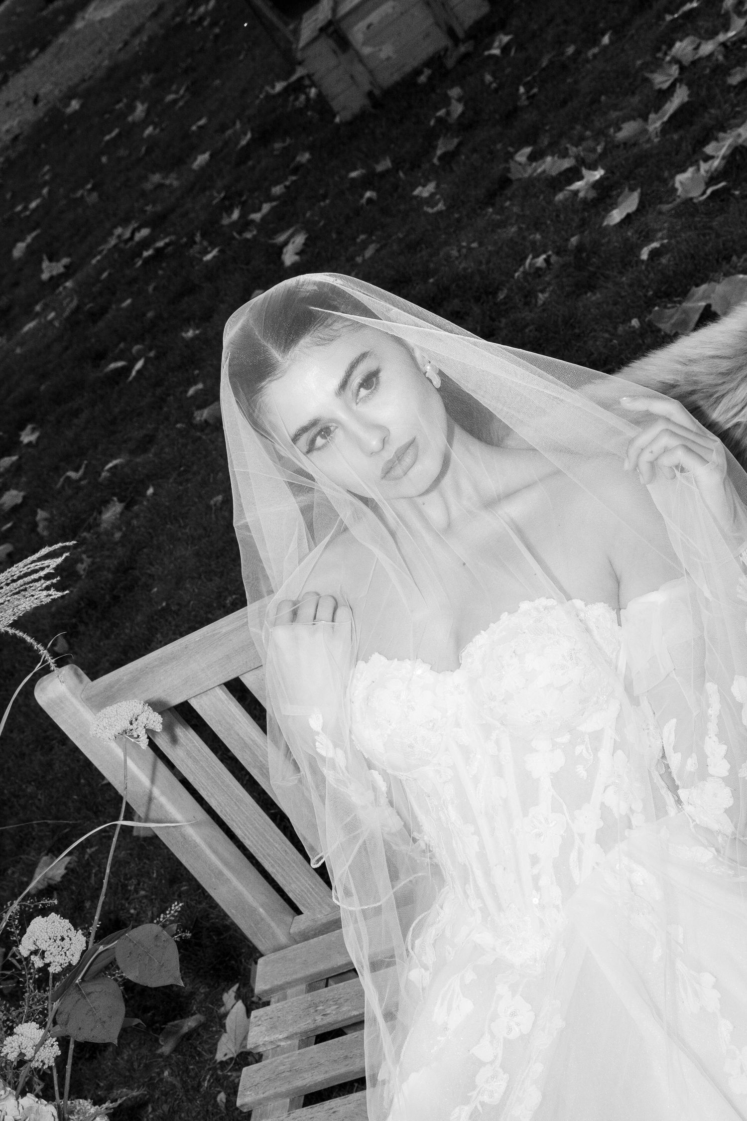 Black and white bridal portraits showing a bride in a flowing white wedding gown and veil against a dark background.