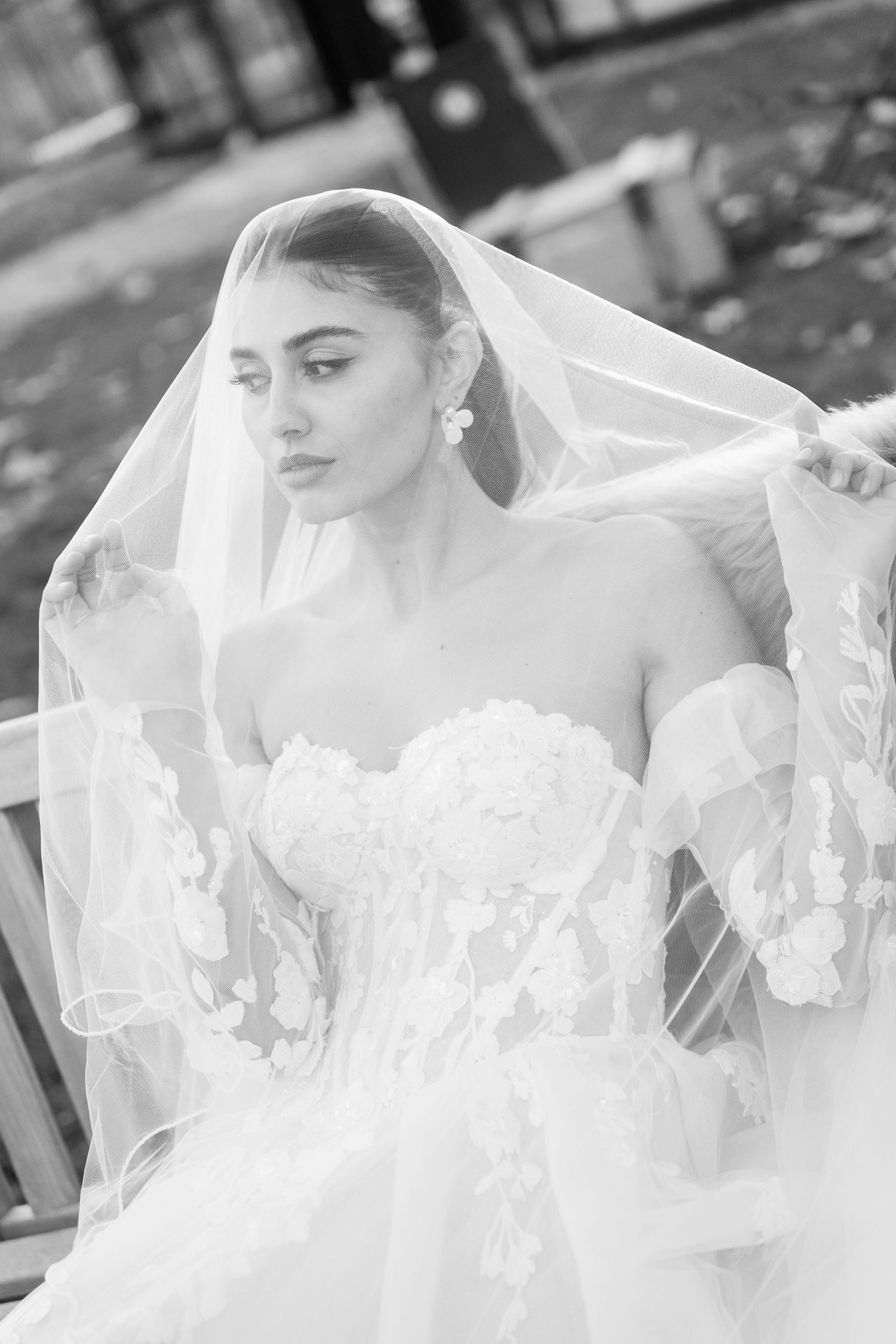 Ethereal black and white series featuring flowing wedding veil and lace details.