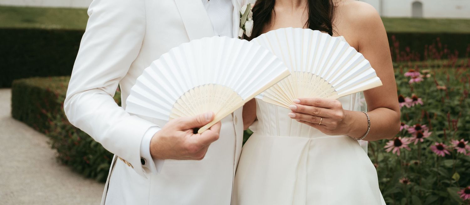 Four cropped photos showing white wedding dresses and paper fans in an outdoor garden setting.