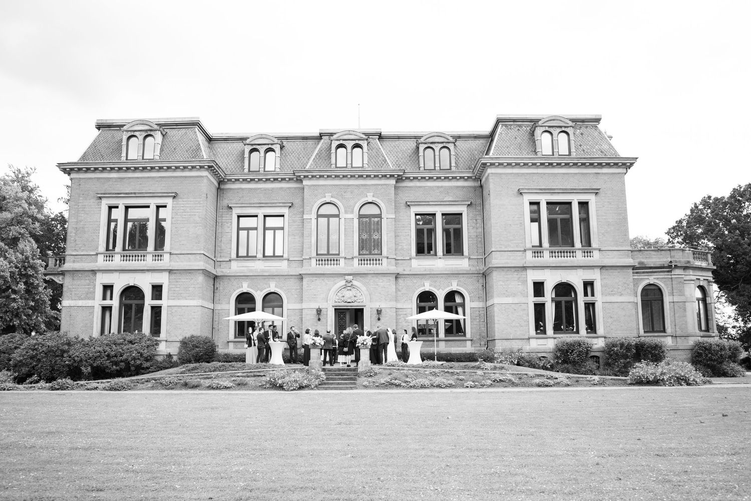Historic black and white photograph showing a series of six views of a grand Victorian mansion exterior.