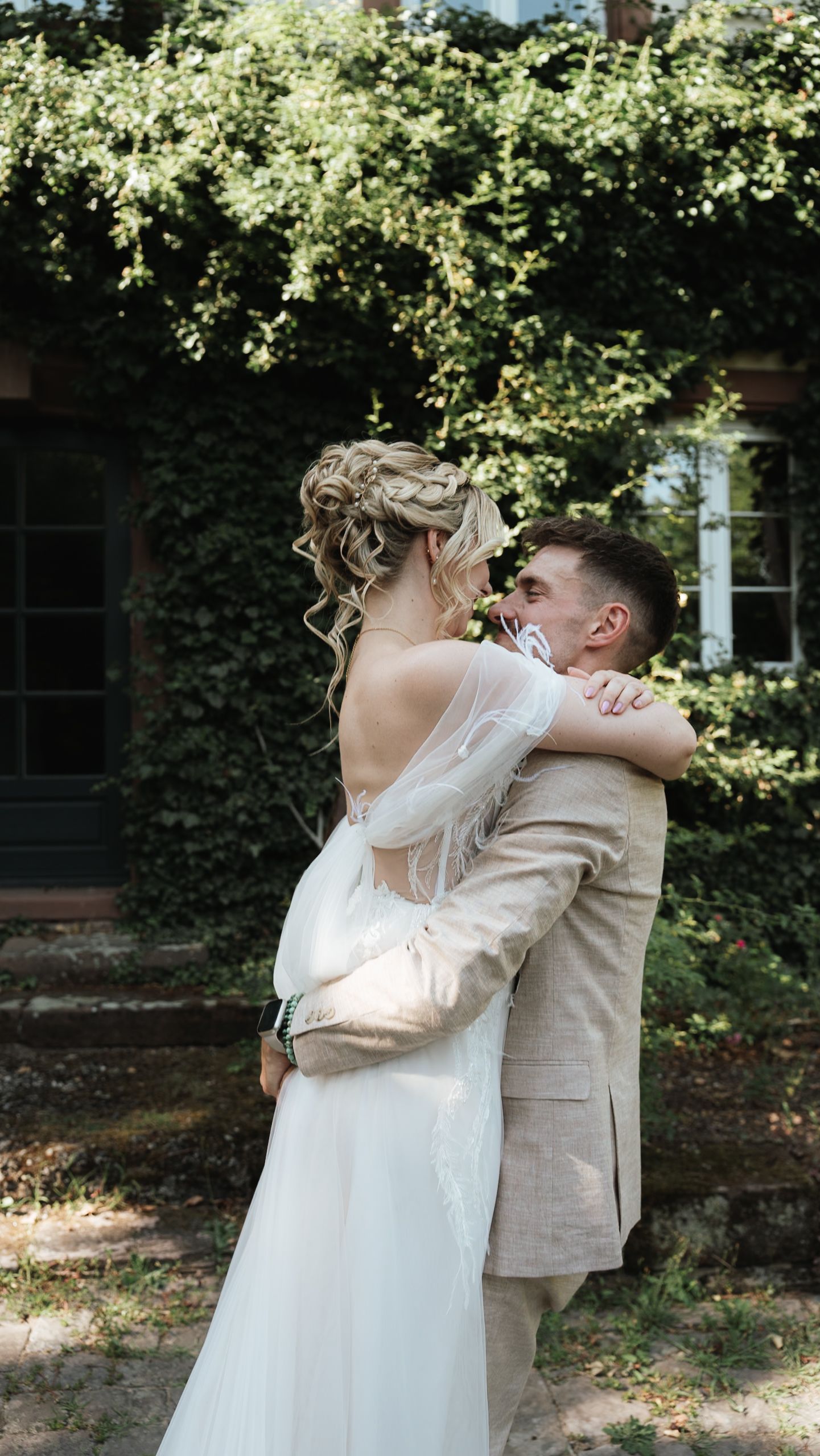 An intimate wedding moment captured in a garden with blooming trees and natural light.