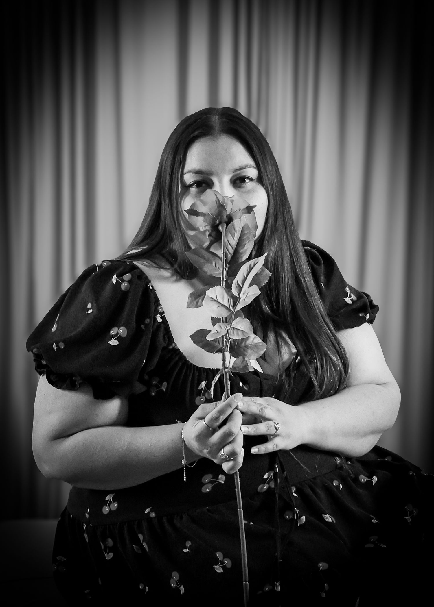 Close up of woman smelling a rose.