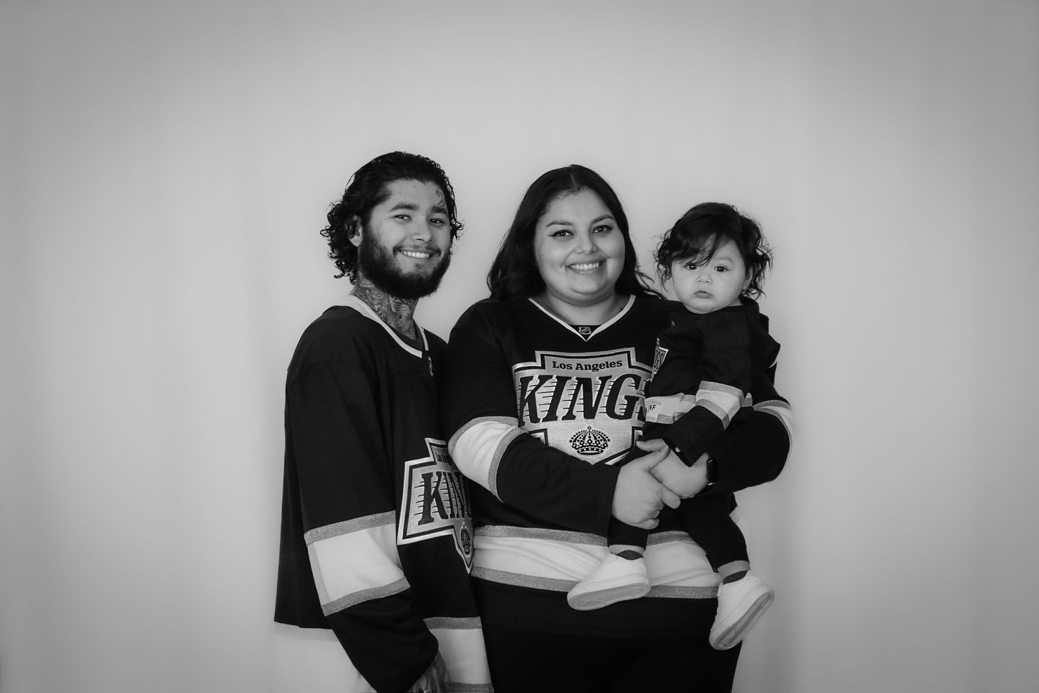 Family behind 818 Films Photography standing and smiling in a studio portrait