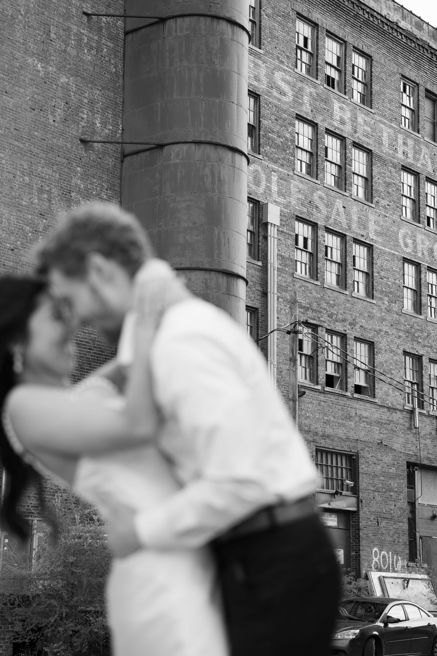 A romantic sequence of dance moves unfolds against an industrial brick wall background.