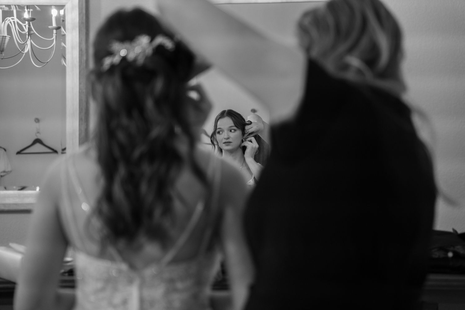 Black and white candid moments captured during wedding preparation.