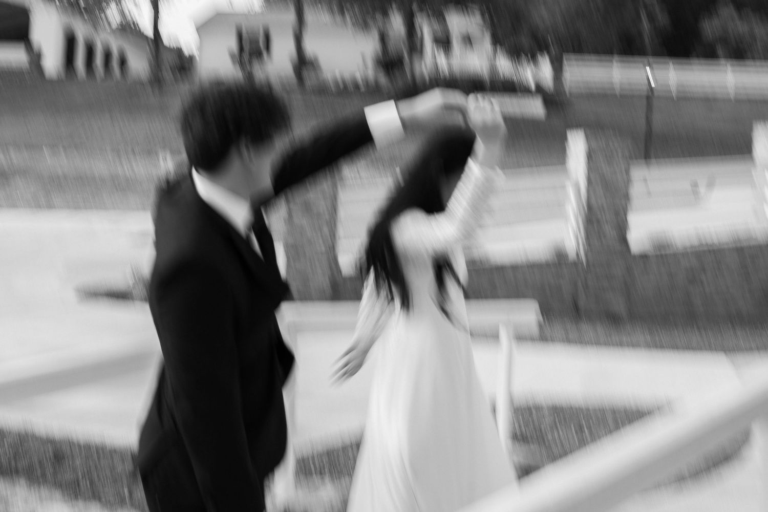 Blurred motion shot of people moving in an outdoor setting.