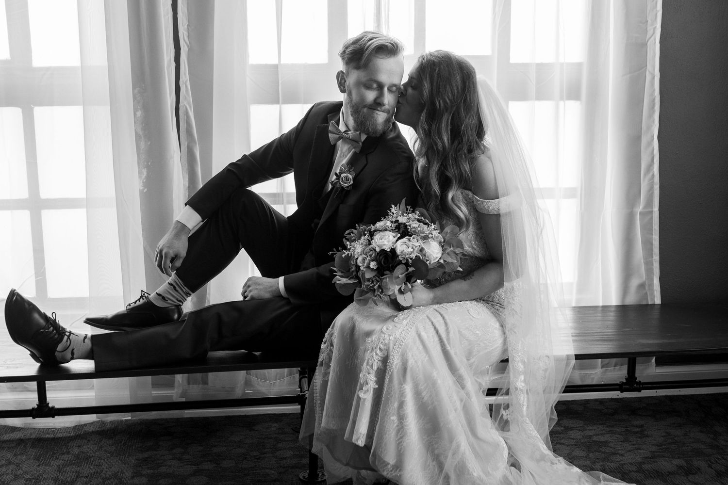 Series of romantic black and white photos showing a couple by a window in formal attire.
