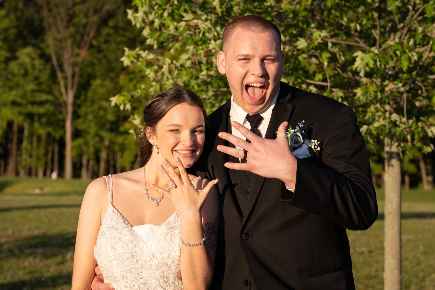 Wedding couple shares playful and candid moments in an outdoor garden setting.