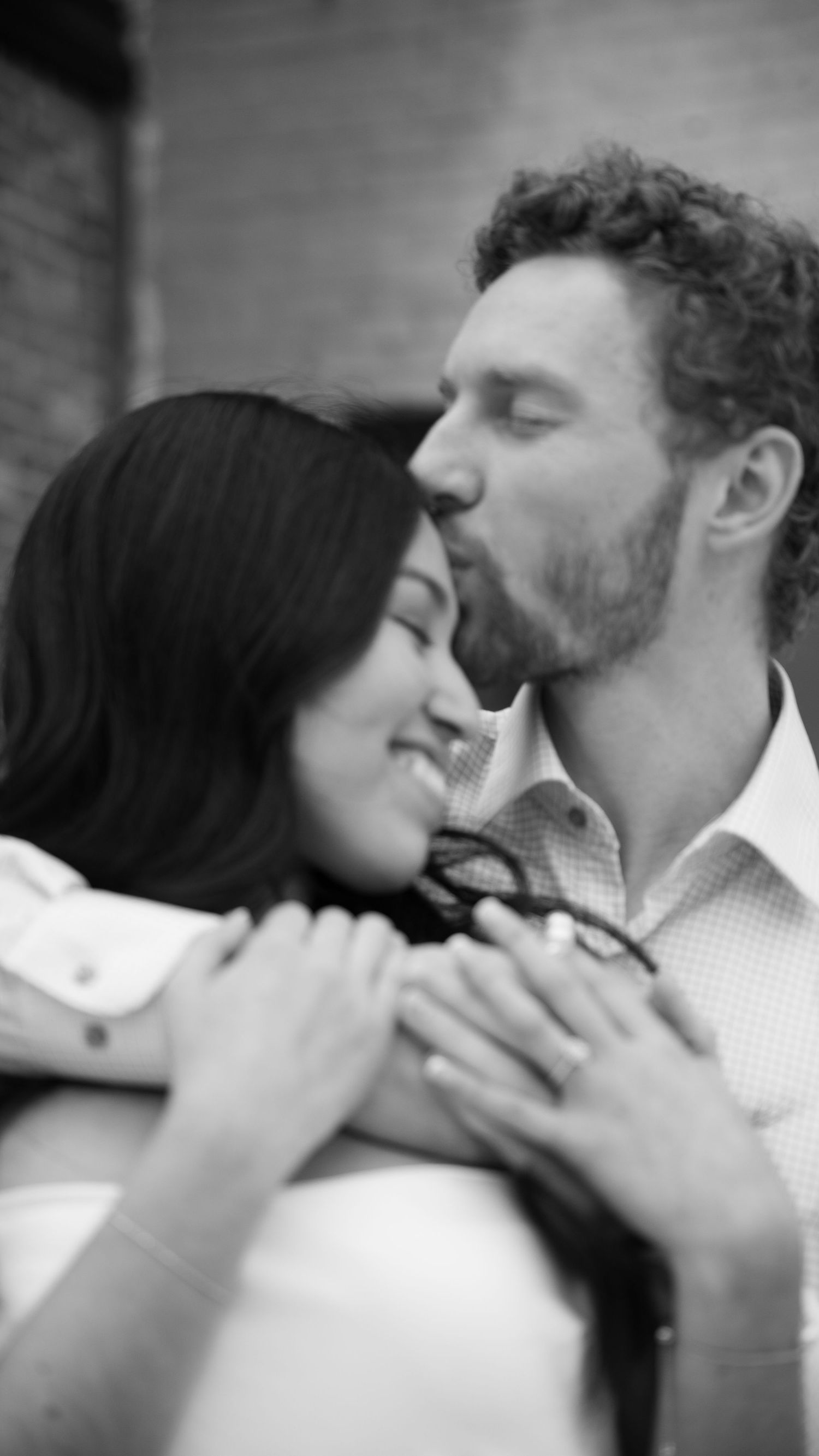 Black and white intimate portrait of couple sharing romantic moment.