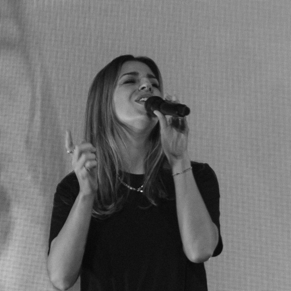 Series of black and white performance photos showing a singer on stage.