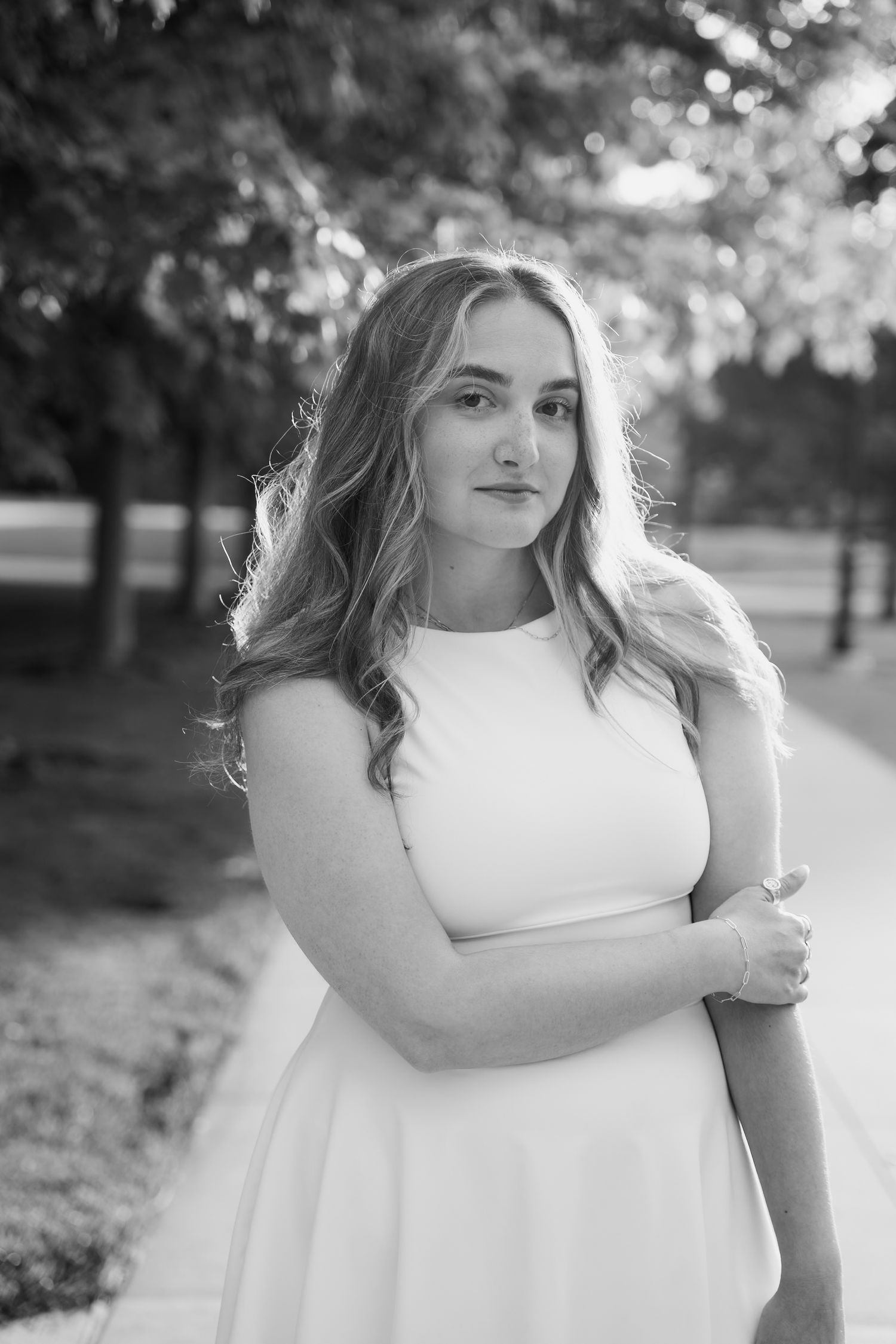 Portrait session in a park with soft natural lighting and bokeh background effects.