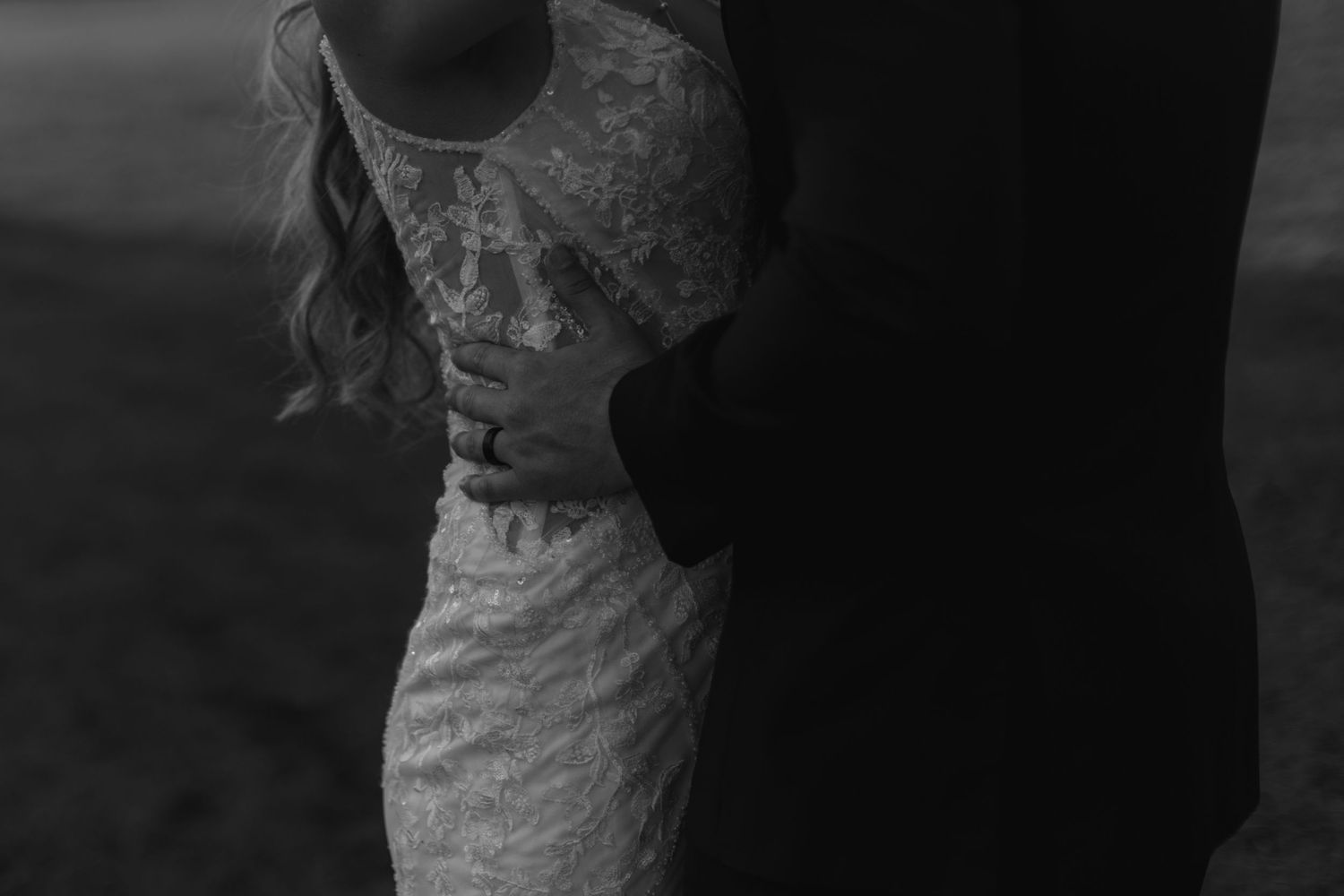 Artistic black and white side profile silhouette of a couple in wedding attire.