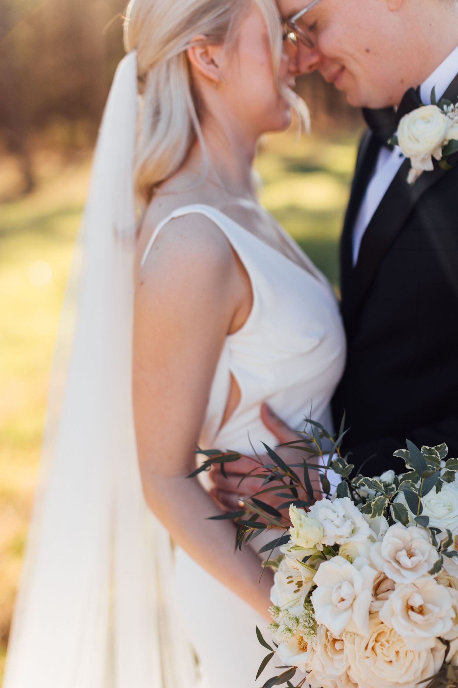 Intimate wedding portraits showcase romantic moments and elegant white floral bouquet.