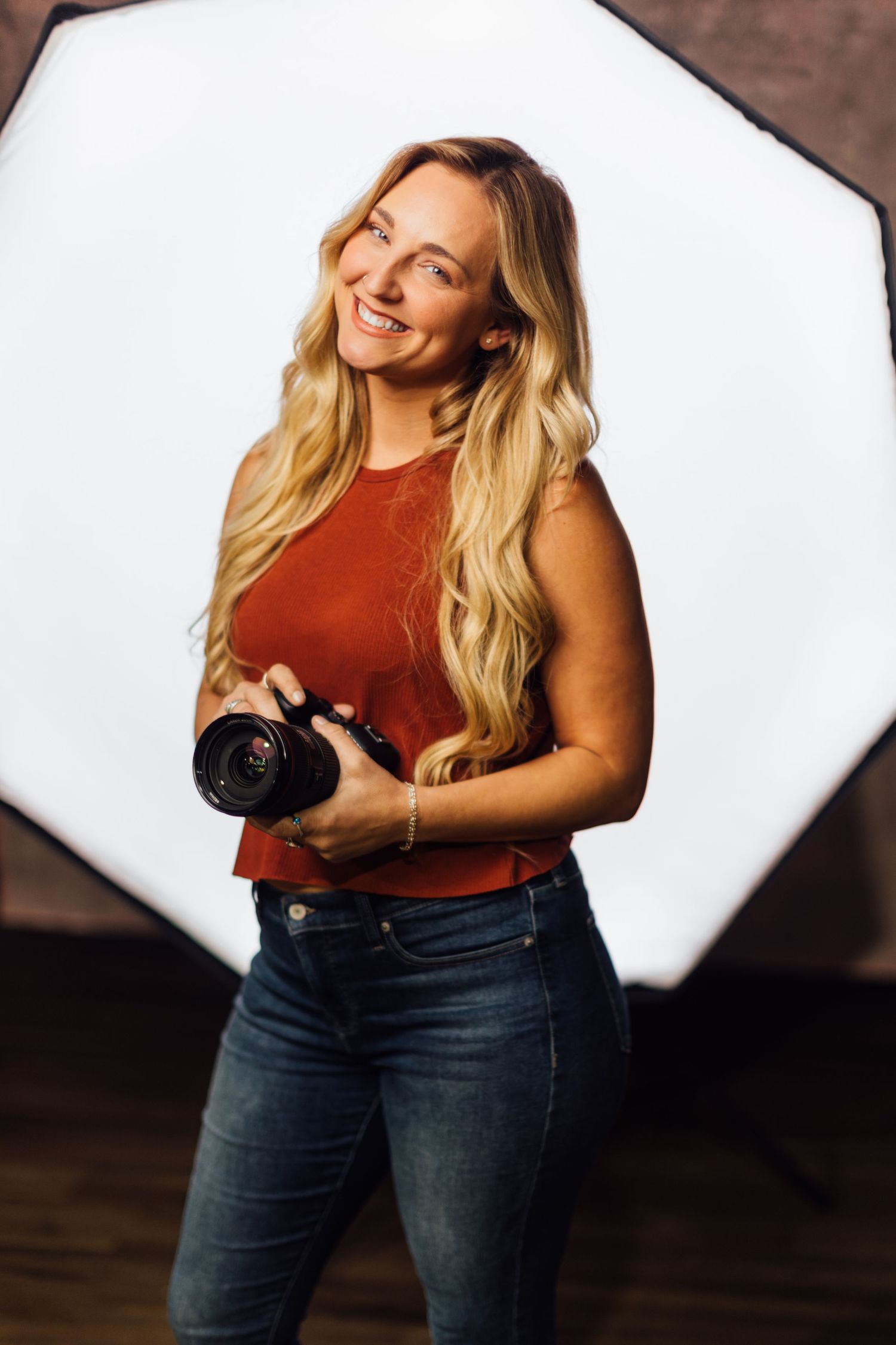 Professional studio photography setup with white backdrop and lighting equipment.
