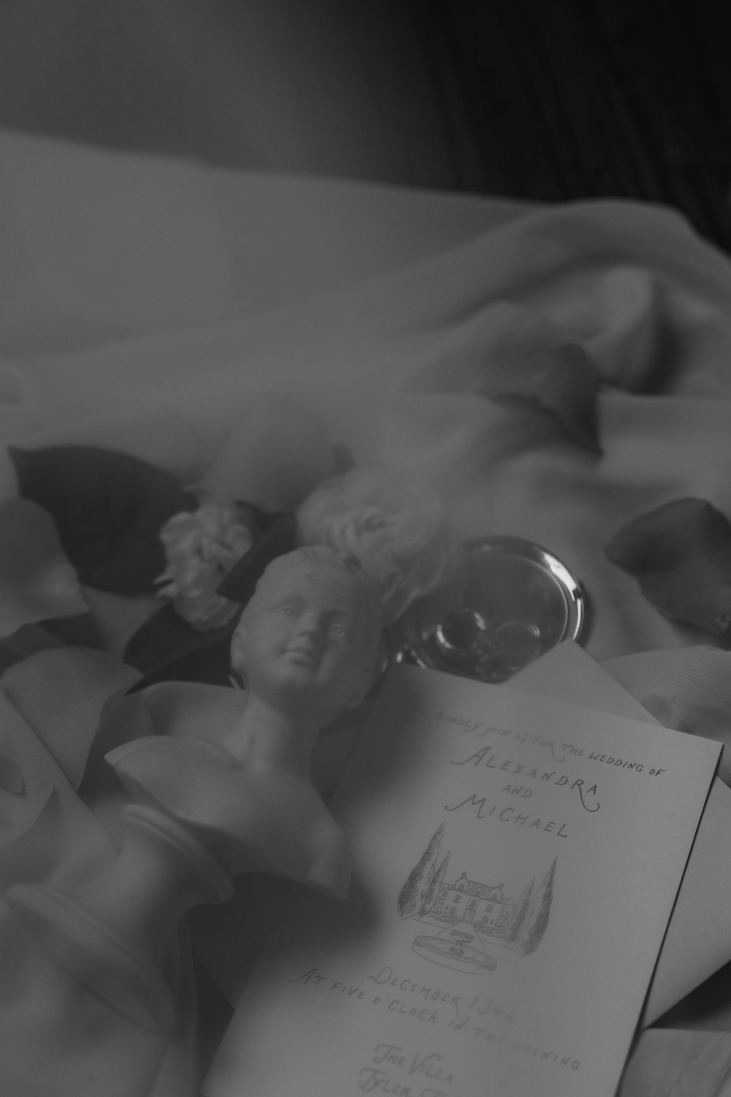 A series of black and white photographs showing handwritten notes and documents laid out on a textured surface.