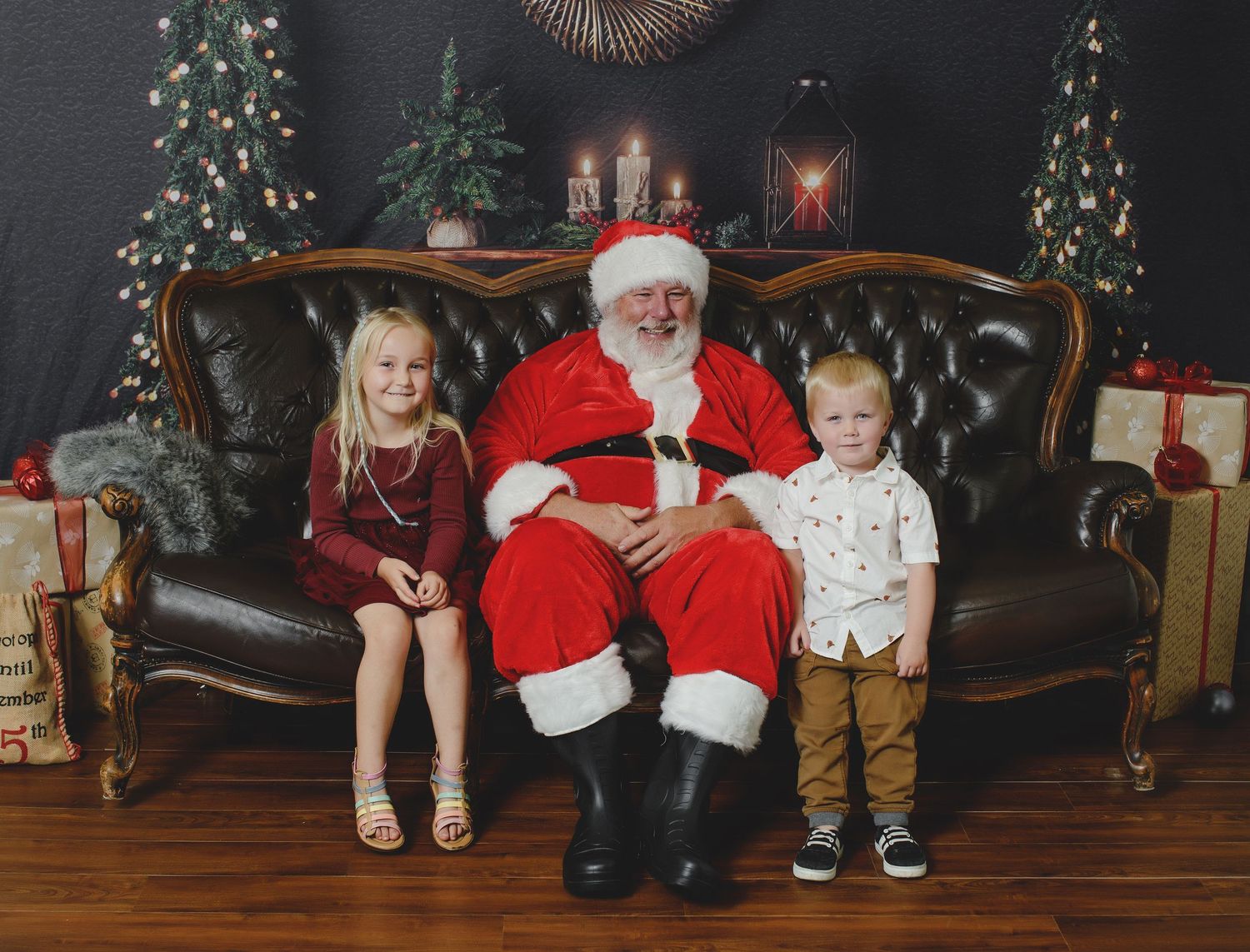 Four holiday photos show children with Santa Claus sitting on a brown leather couch with Christmas decorations in the background.