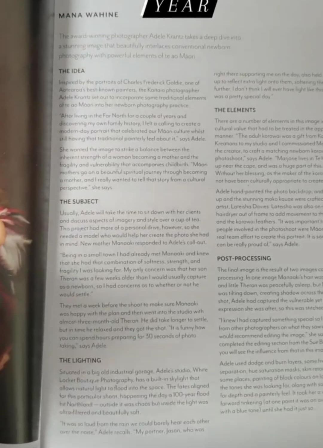 Close-up view of a book page with text visible, shows someone's fingers holding the page corner.