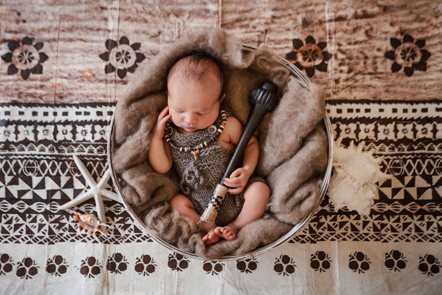 Several detailed images showing hands holding a baby against a decorative patterned rug or blanket background.