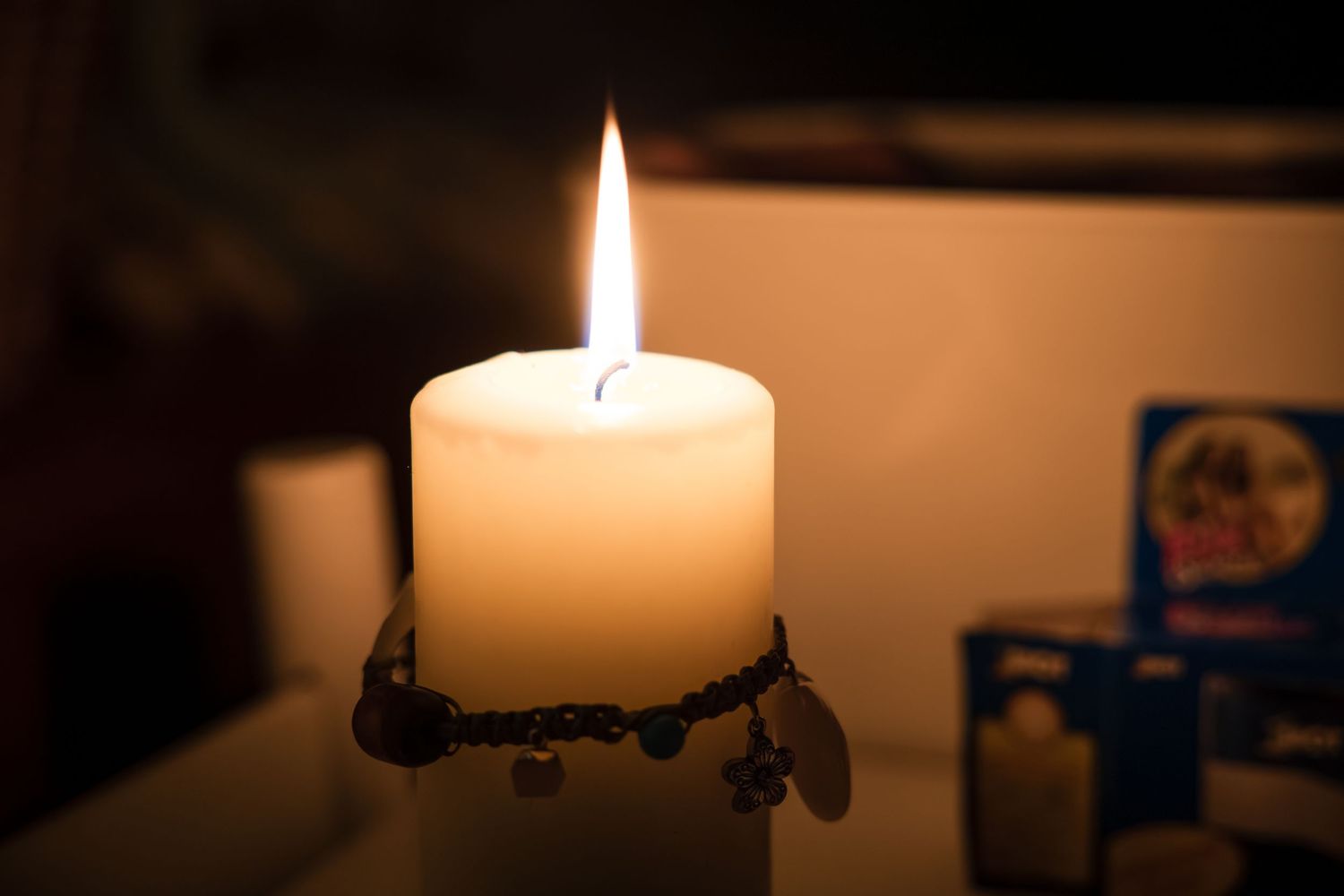Warm candlelight glowing in darkness creating a peaceful ambiance.