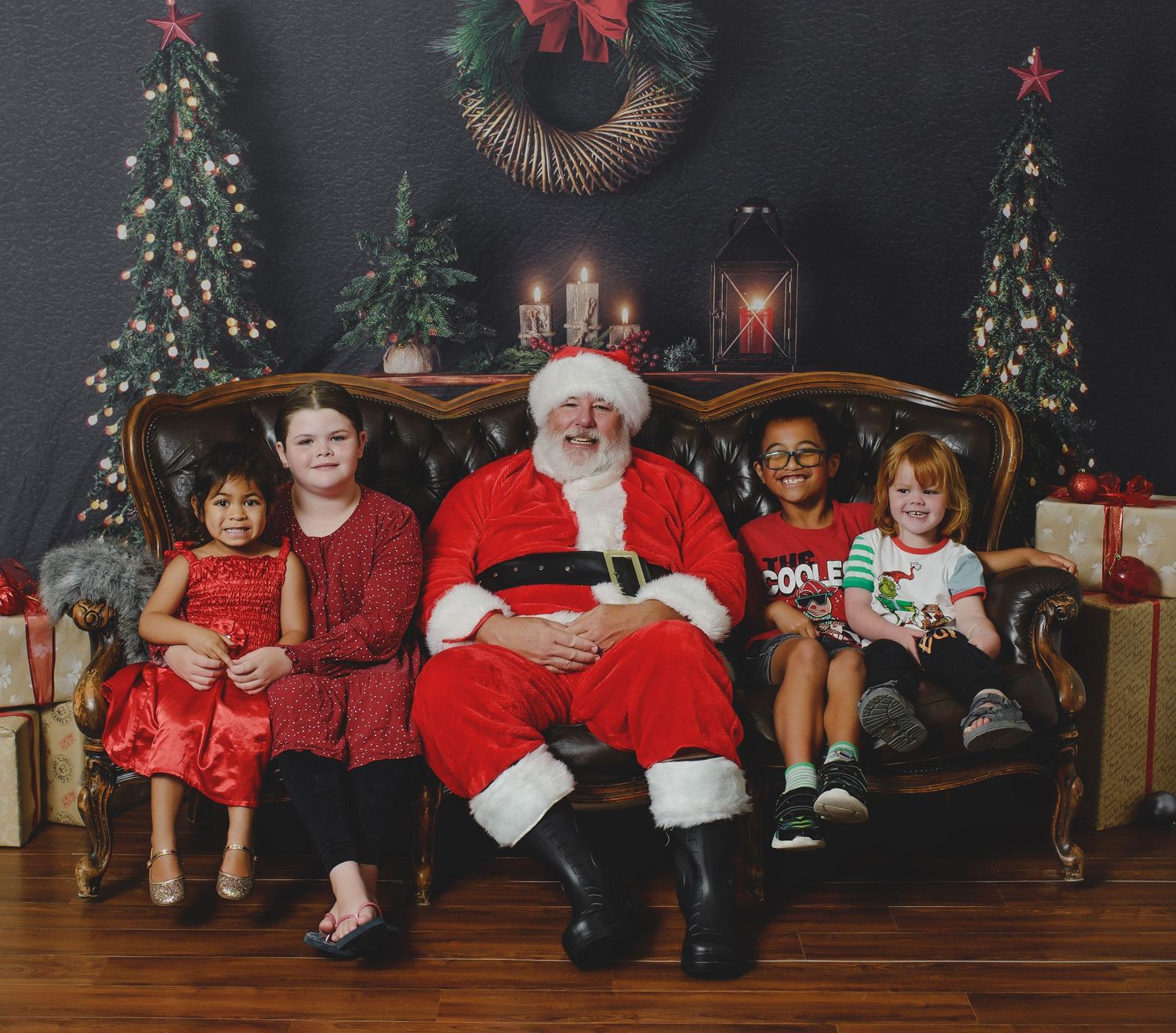 A festive Christmas scene with a decorated tree, wreath, and vintage couch against a dark backdrop.