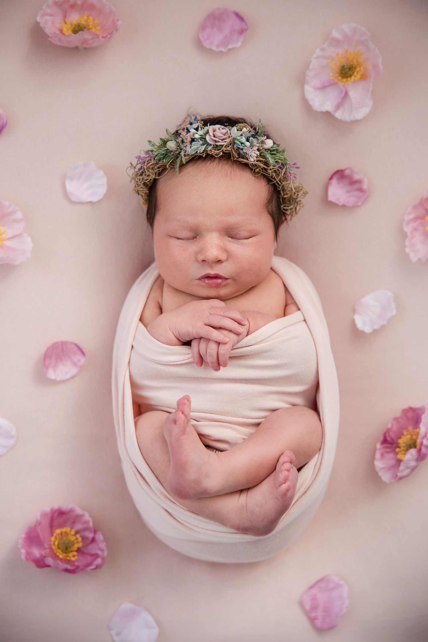 Newborn photography collage with baby in white bowl surrounded by delicate pink flower petals on beige background.