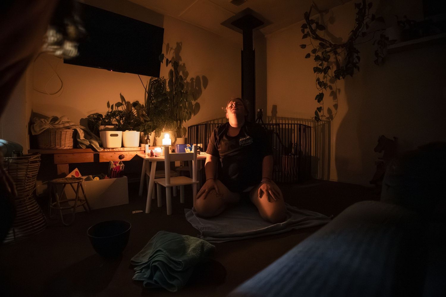 A sequence of dimly lit photos showing a dark interior room with candlelight creating atmospheric shadows.