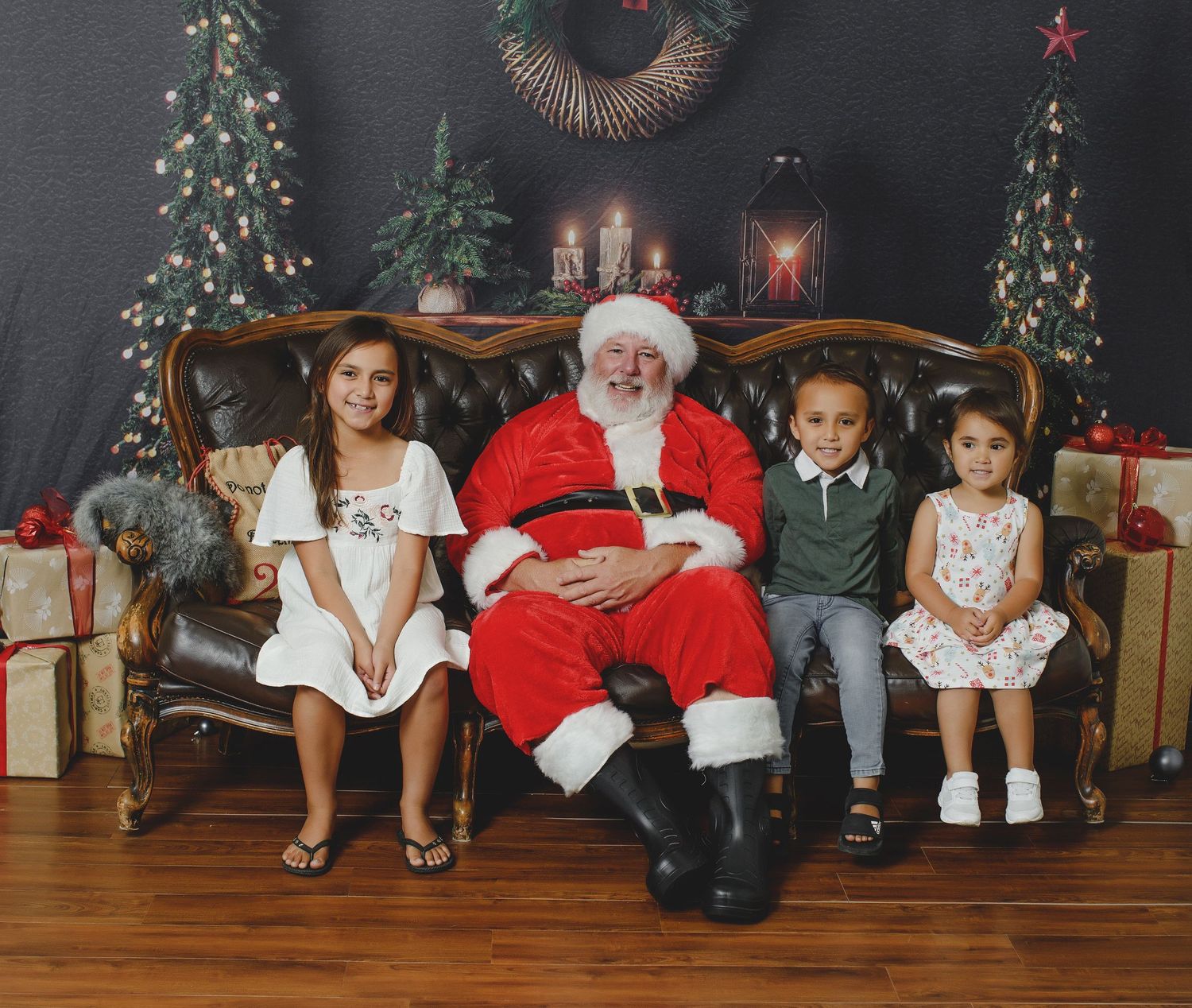 A cozy Christmas scene with decorated trees, presents, and a traditional holiday setup on a wooden floor.