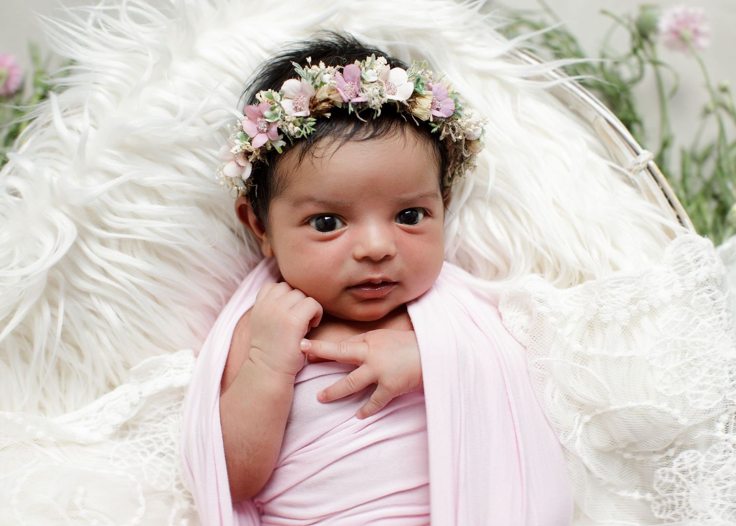 Sweet baby dressed in pink wearing delicate floral crown against white feathered background. Cambridge Waikato NZ Photographer