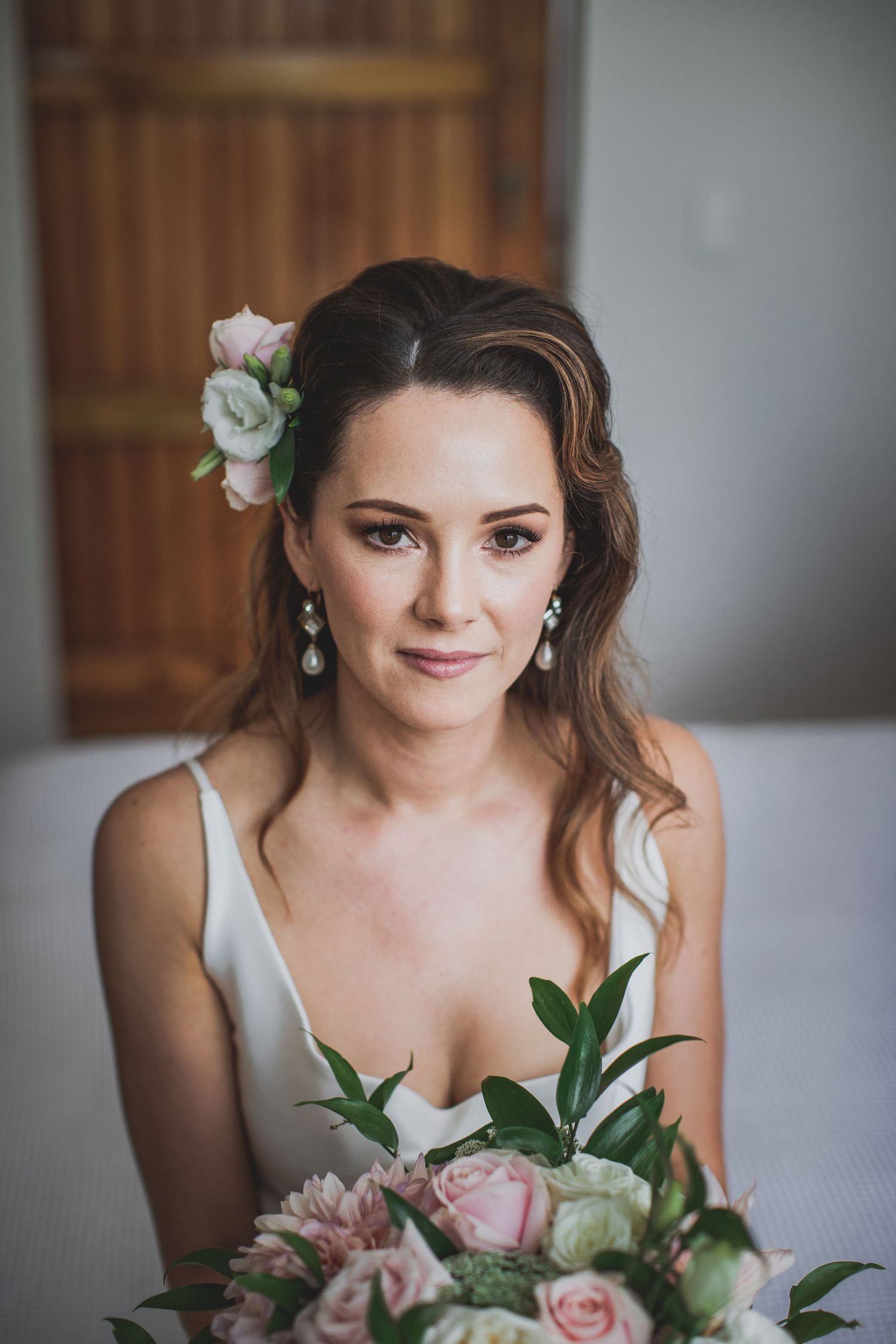 Elegant bridal portrait with soft makeup and floral hair accessory holding pastel bouquet. Cambridge Waikato NZ Photographer. White Locket