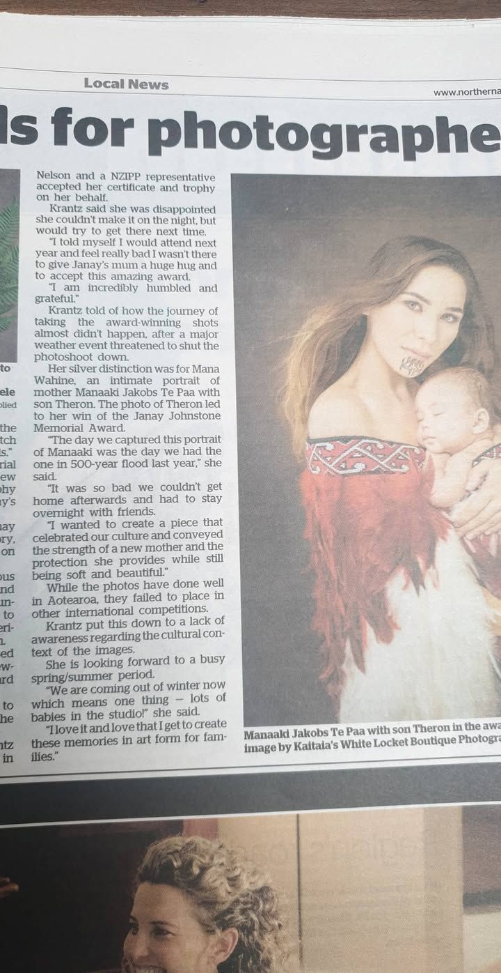Newspaper article about photographer with portrait image in grayscale tones showing long dark hair and soft lighting.