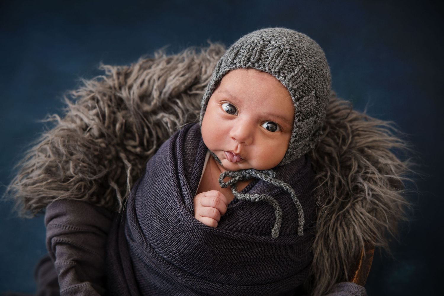 Close up photo series showing playful expressions and different angles of someone wearing a fur-trimmed winter coat.