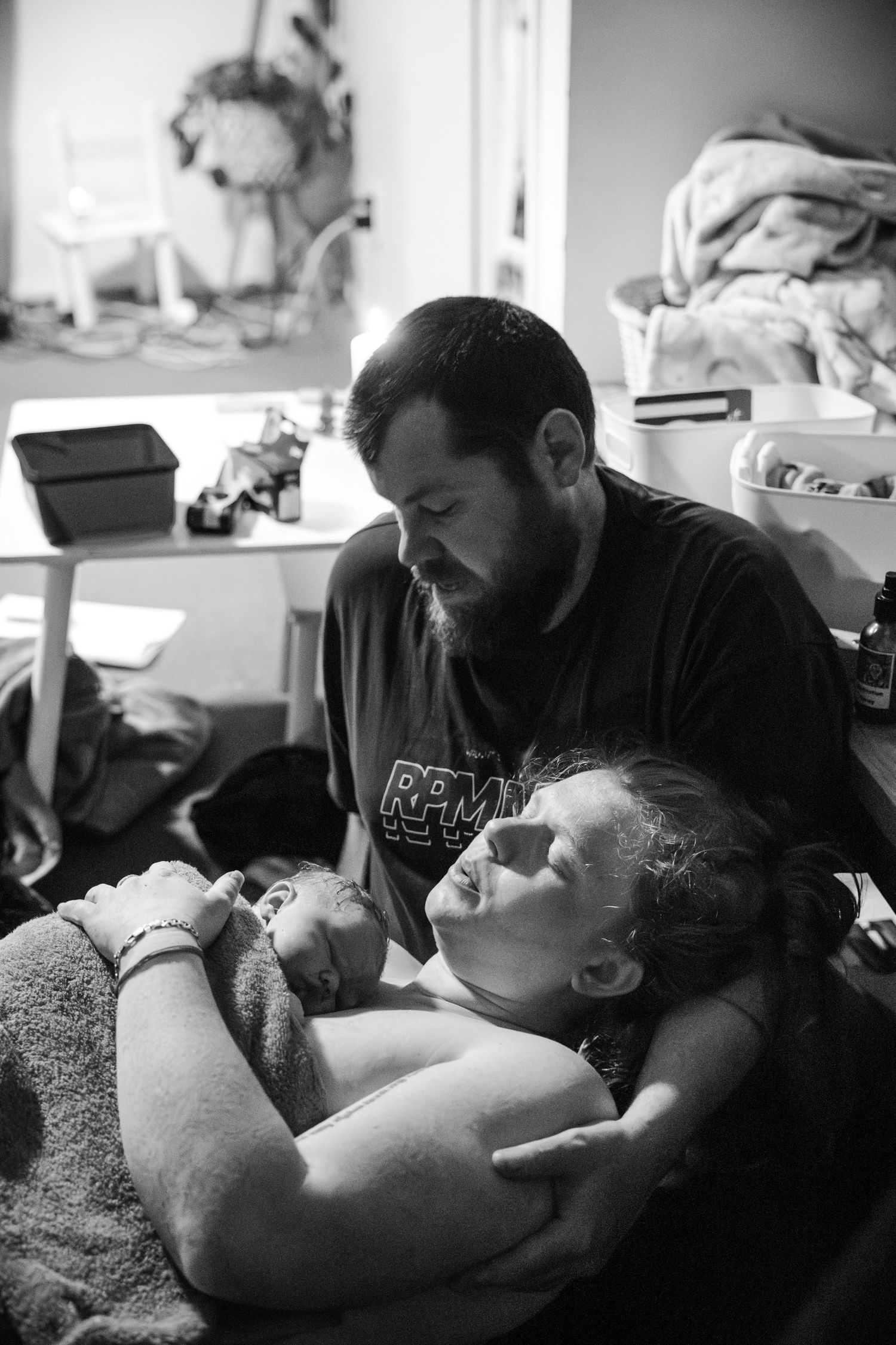 A series of black and white photos showing a person getting a tattoo while lying on a table.