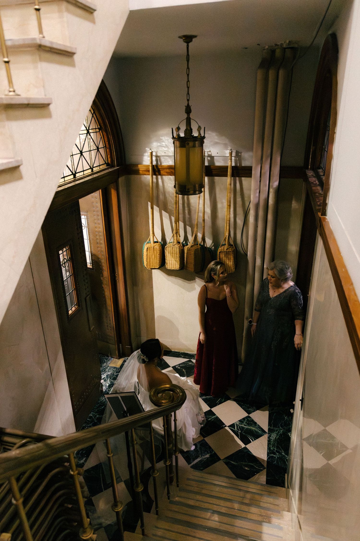 Multiple dark interior hallway views showing people moving through a dimly lit corridor with hanging light fixtures.