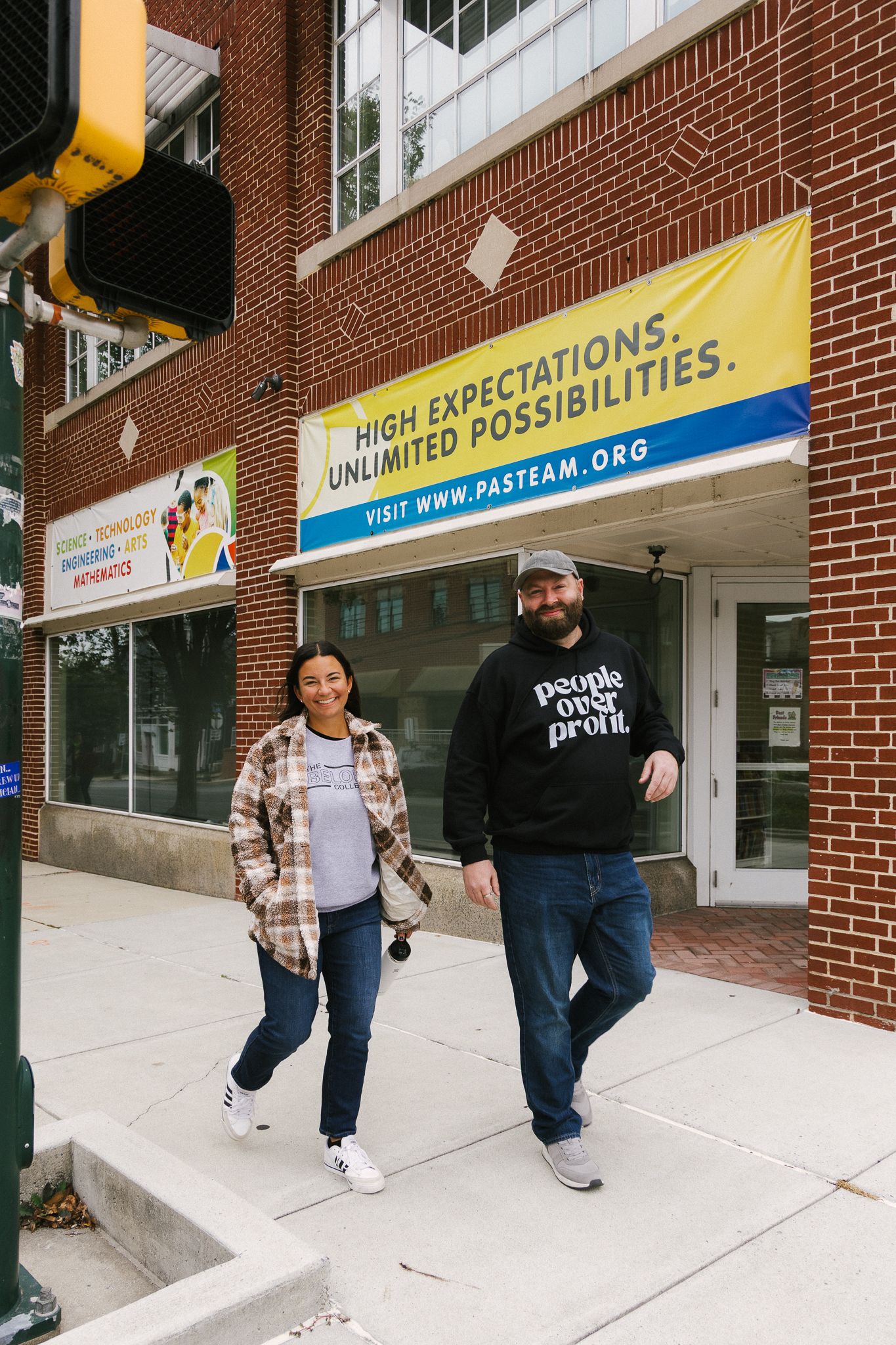 A sequence of three photos showing people walking up a ramp entrance to a brick building with signage.