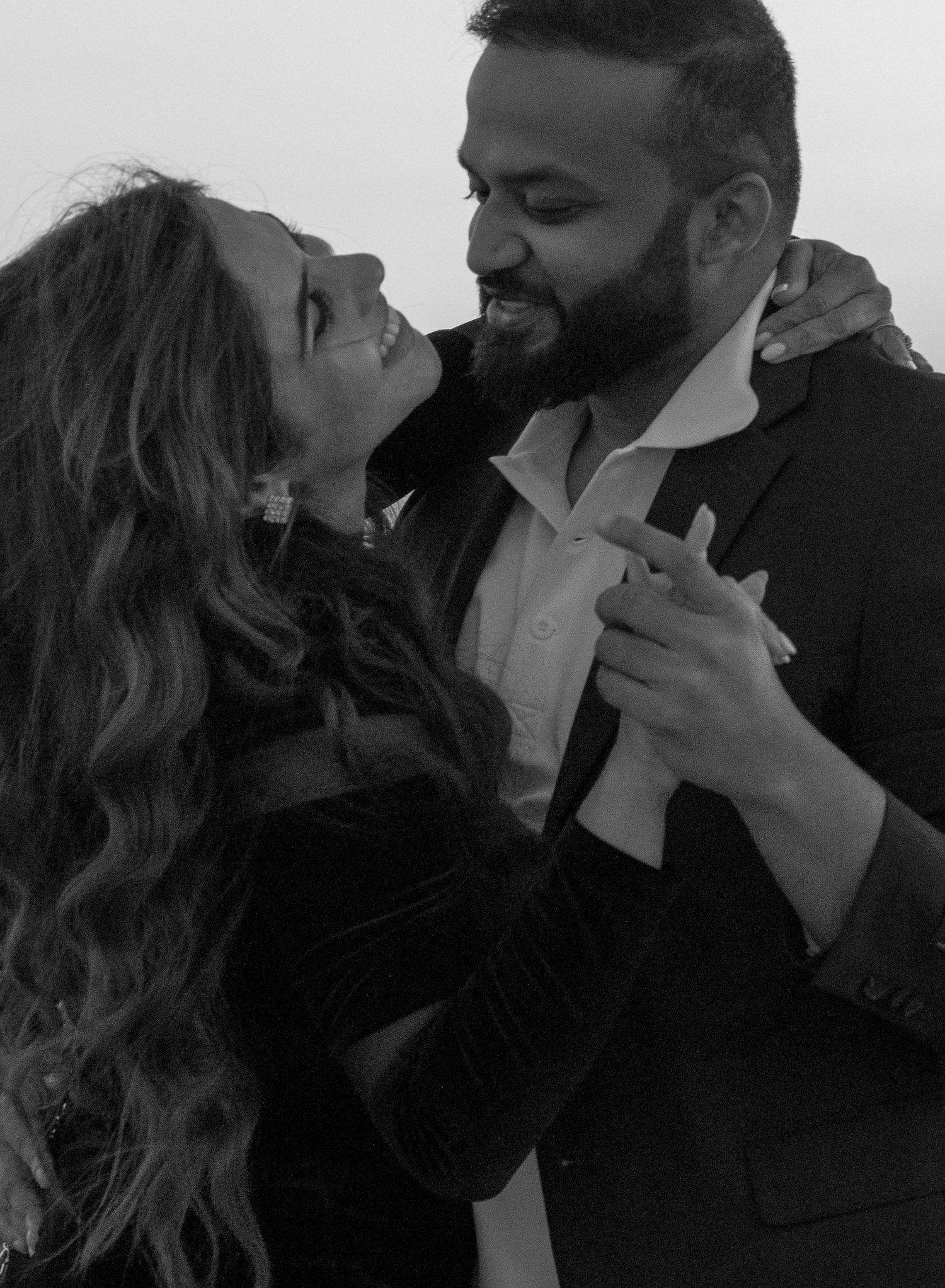 Intimate black and white portrait of couple dancing and sharing a romantic moment.