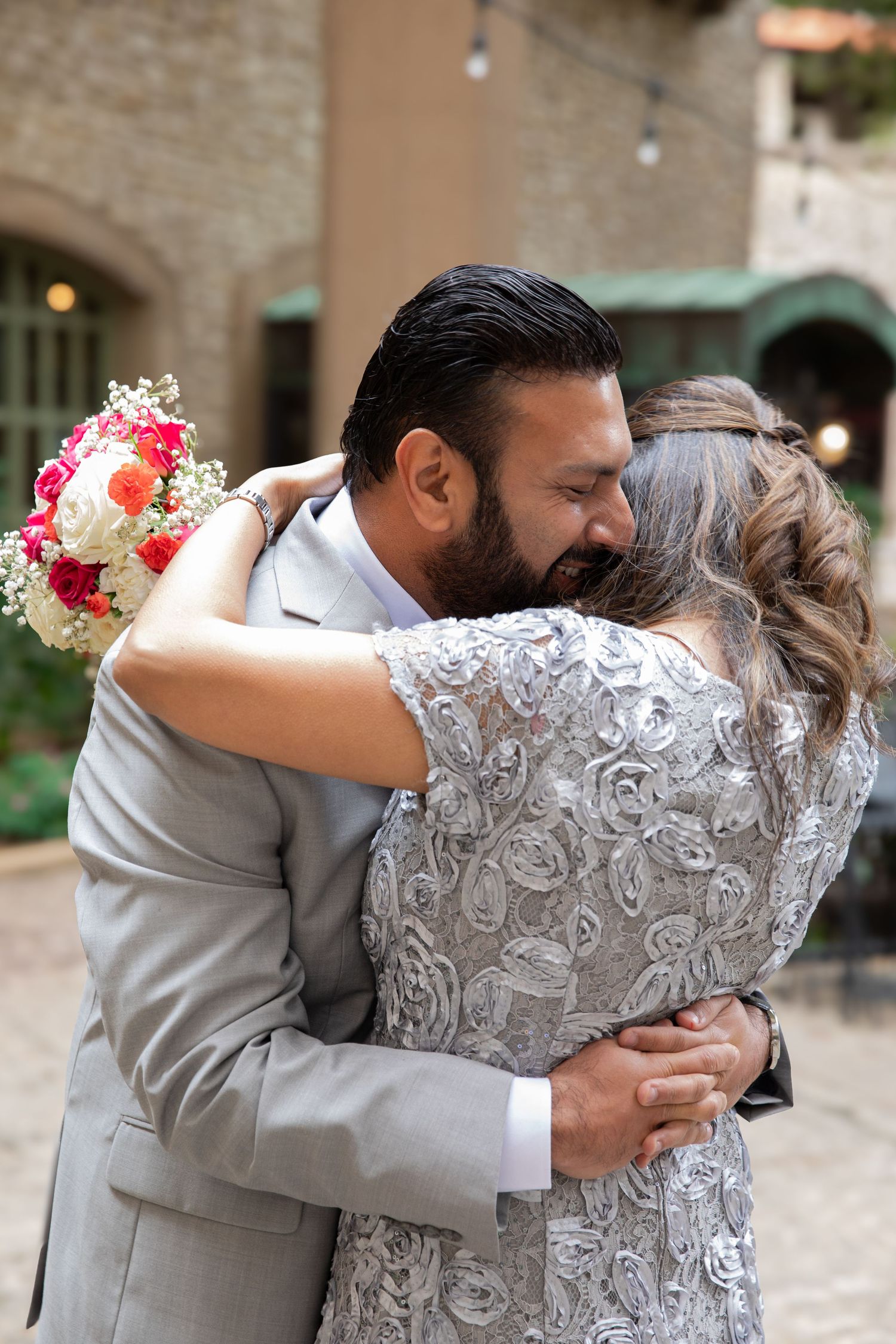 Wedding photography sequence showing embraces in formal grey and white attire.