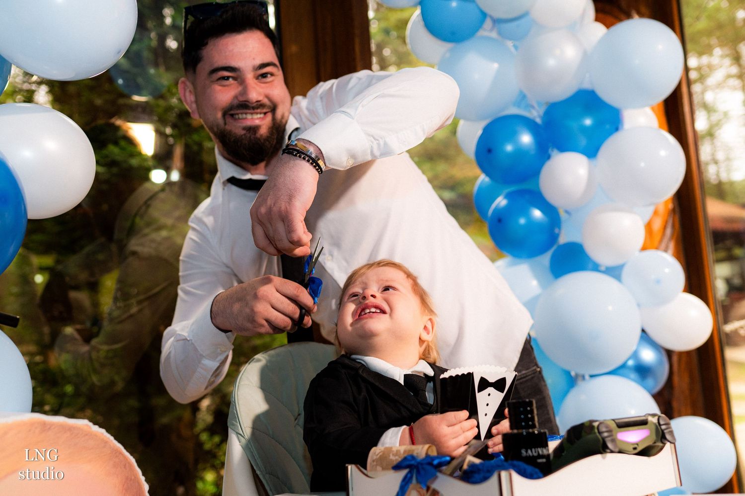 Birthday celebration with blue and white balloon decorations and festive party atmosphere.
