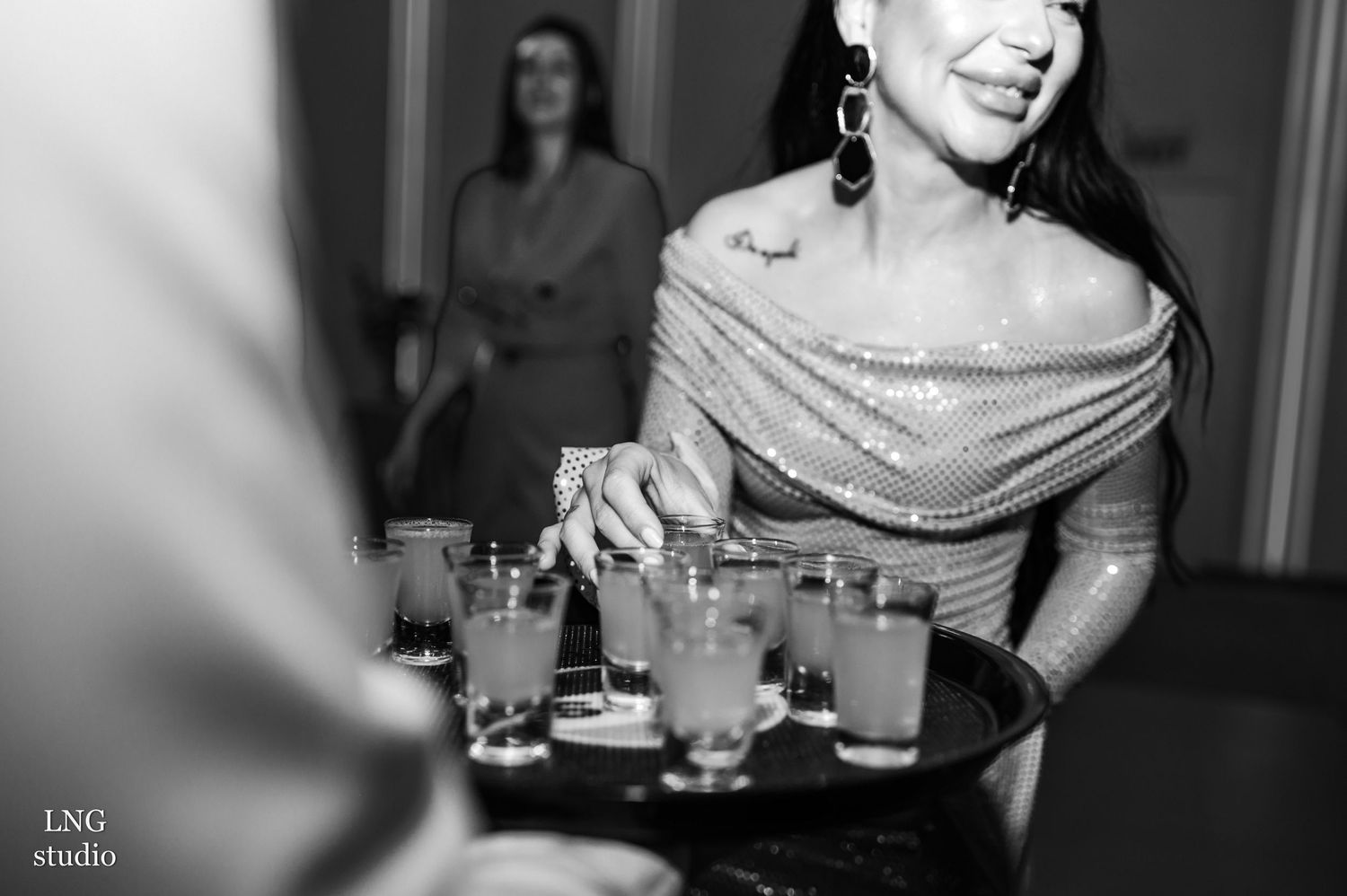Black and white photo of people at a party or social gathering.