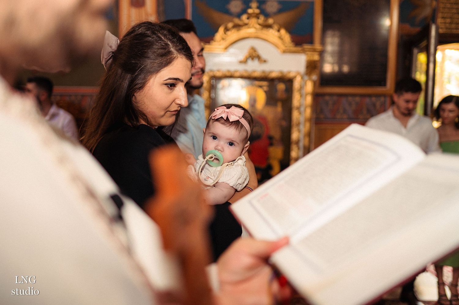 Religious ceremony showing an ornate golden mirror in the background.