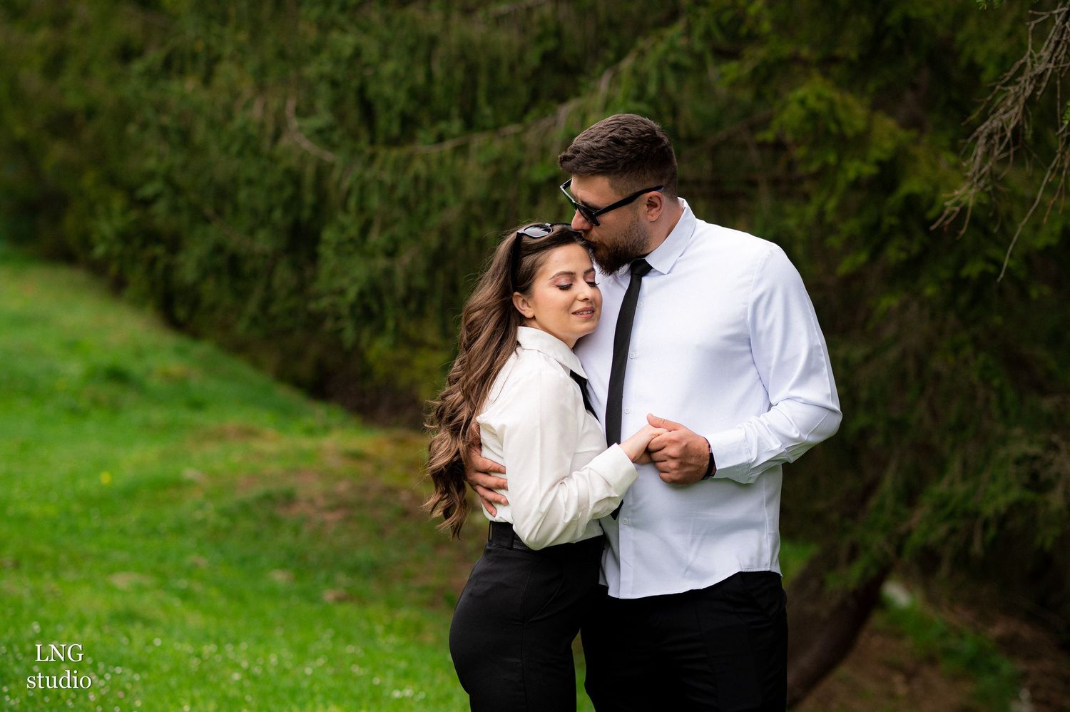 Intimate couple portraits in black and white attire outdoors.