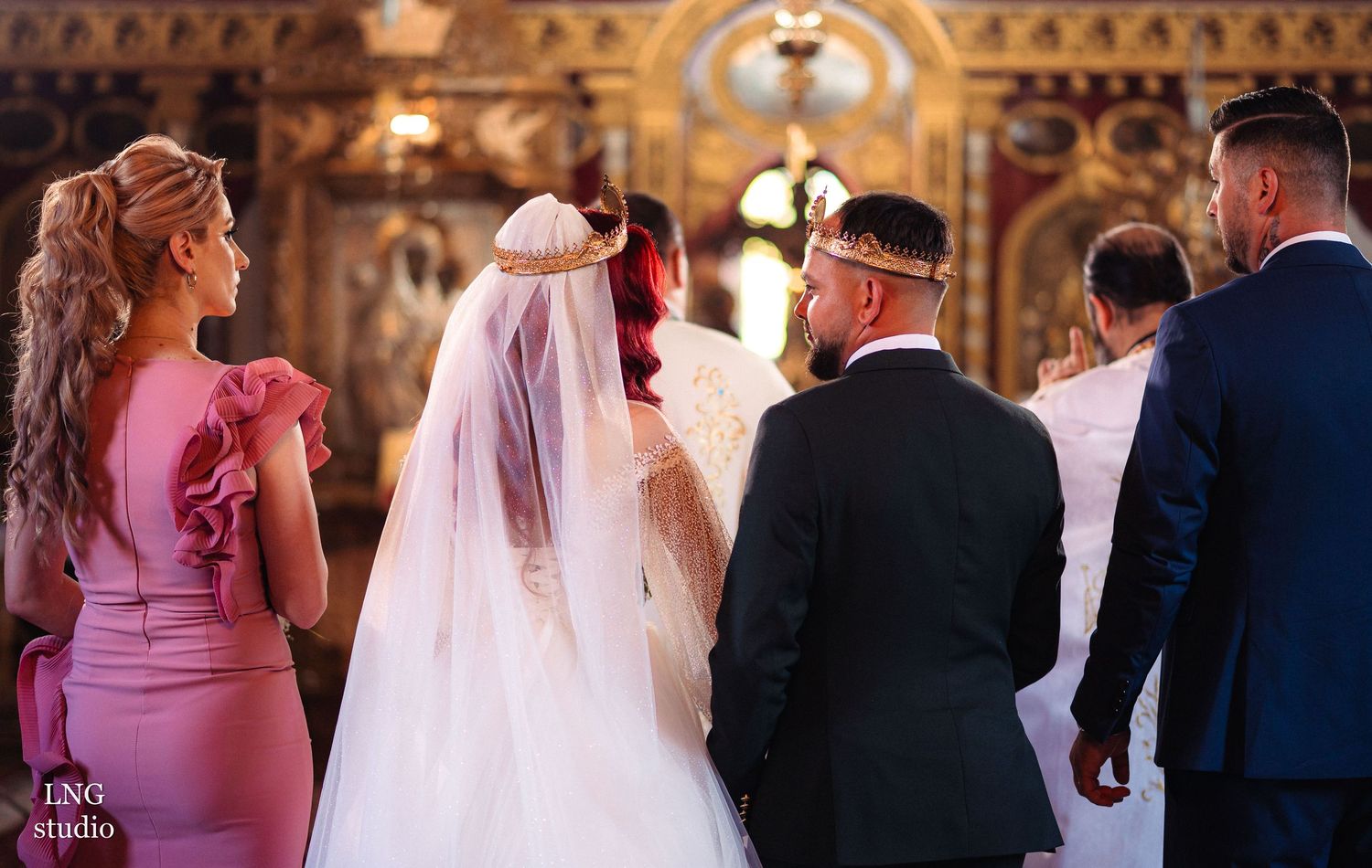 Traditional Orthodox wedding ceremony in ornate church interior.