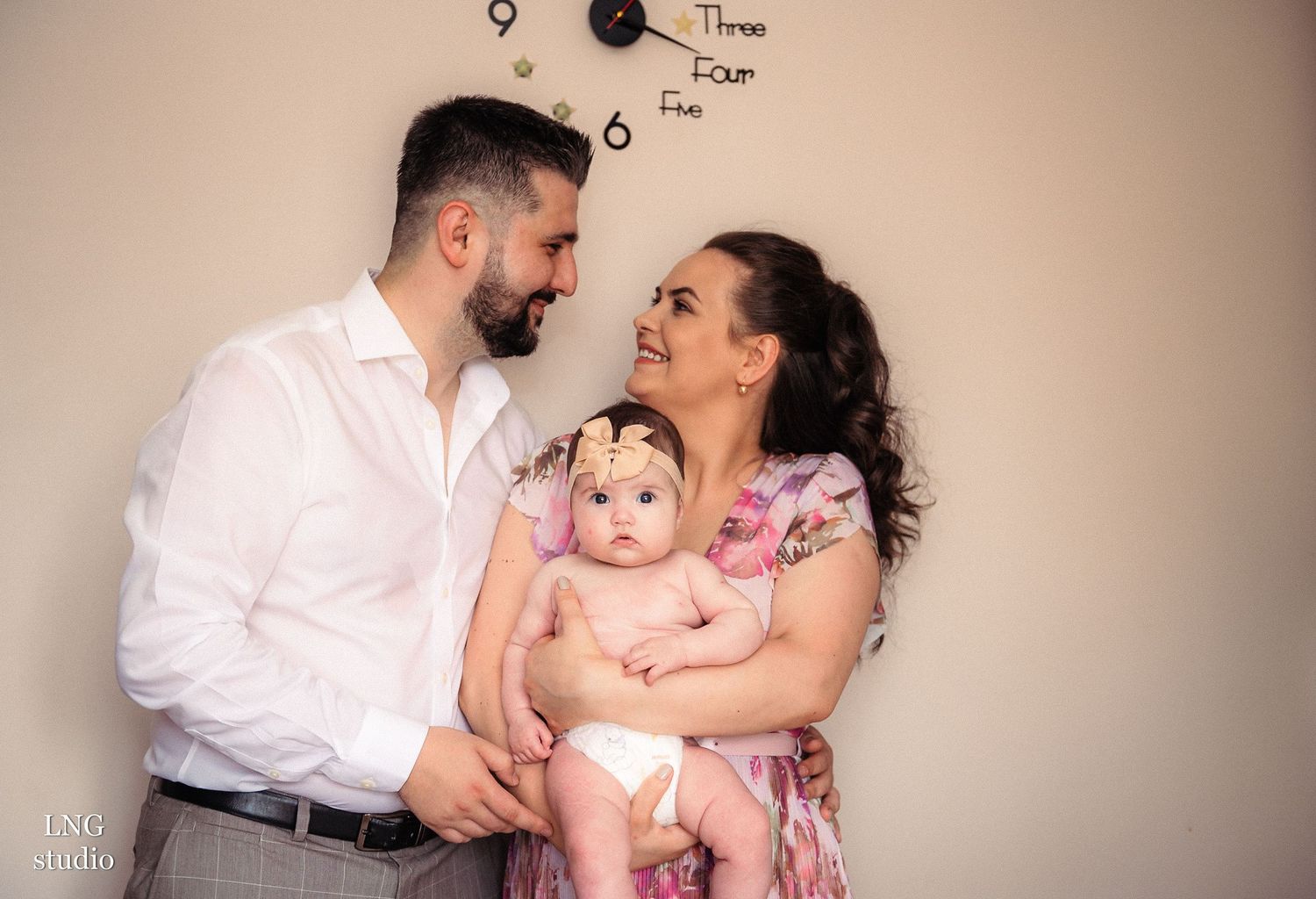 Family portrait session showing joyful moments and laughter in neutral tones.