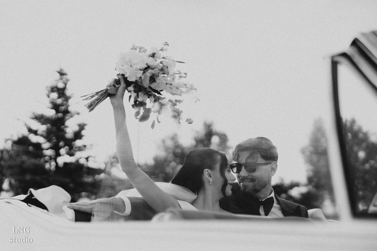 A series of black and white artistic photographs of what appears to be a wedding reception arranged in a filmstrip layout.